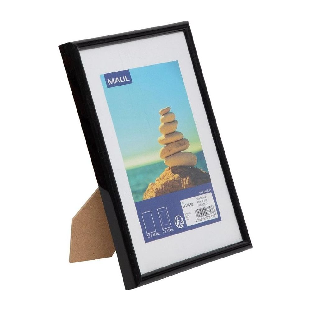 Schwarzer Bilderrahmen mit weißem Passepartout und einem Foto von Steintürmen am Strand.