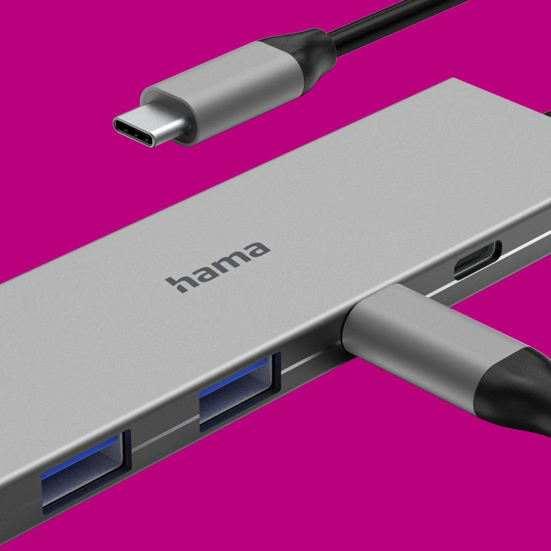 Srebrny hub USB Hama z wieloma portami i podłączonym kablem USB-C na tle w kolorze magenty.