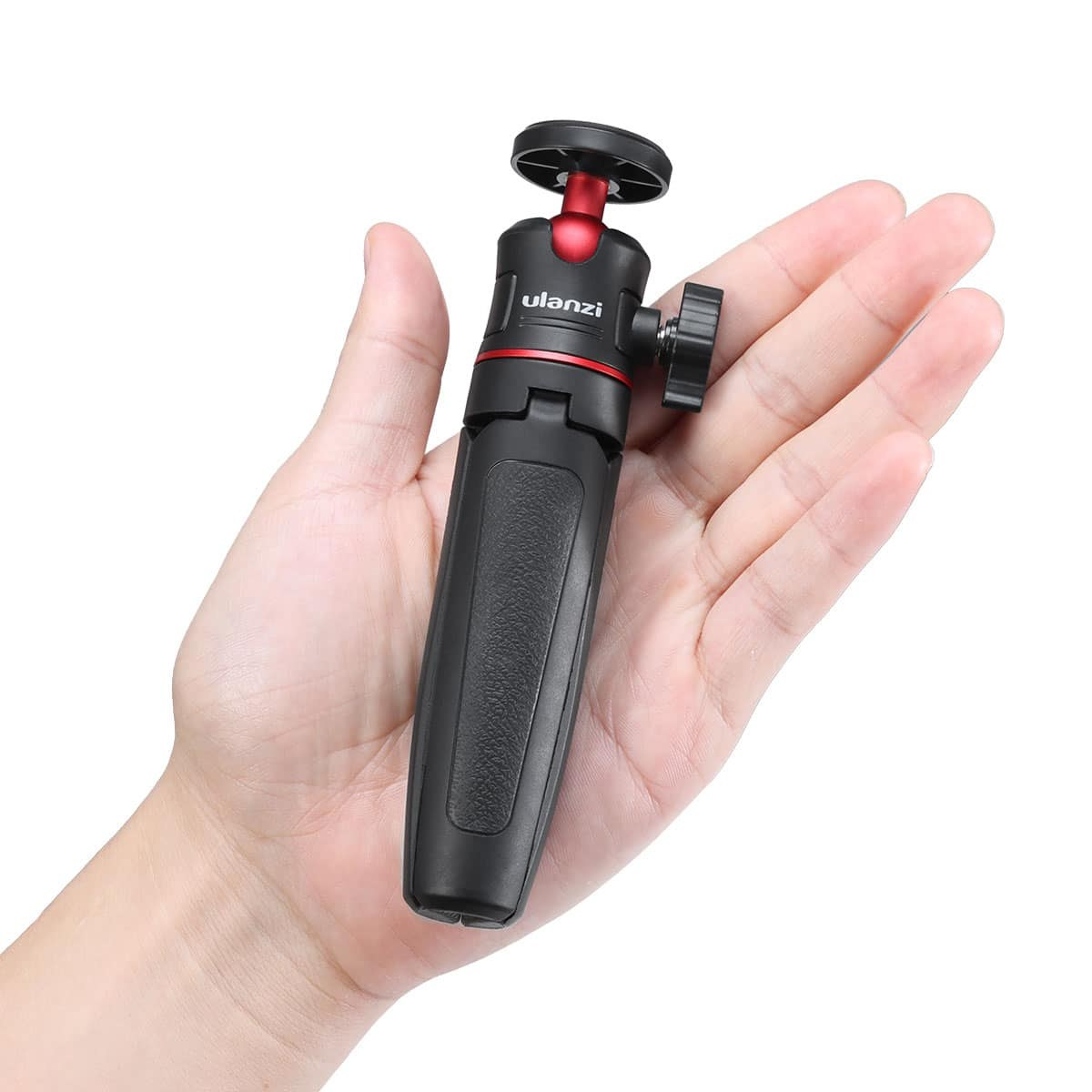 A hand holds a compact, black and red Ulanzi mini tripod on a white background.