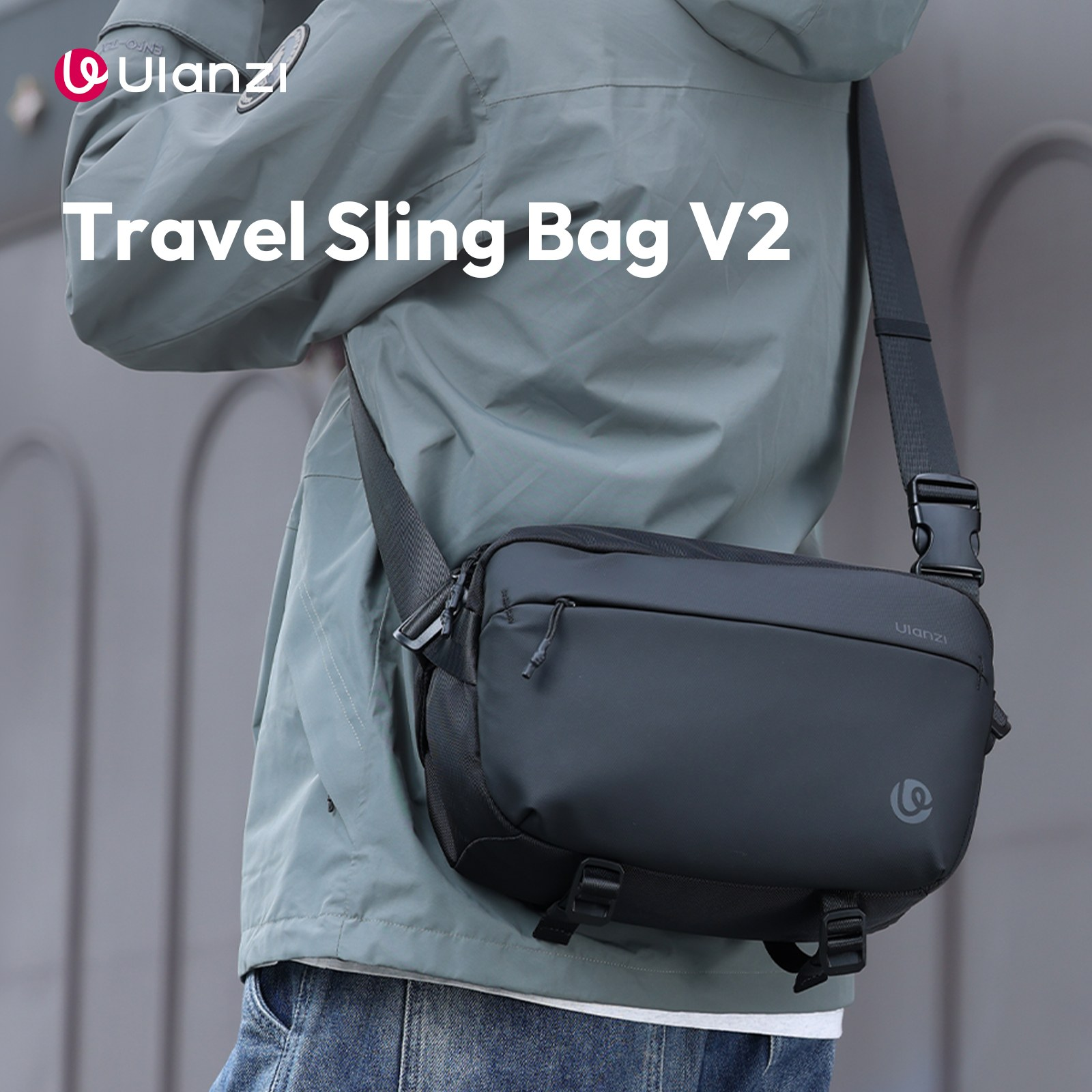A person in a gray jacket and jeans wears a black sling bag across their chest.