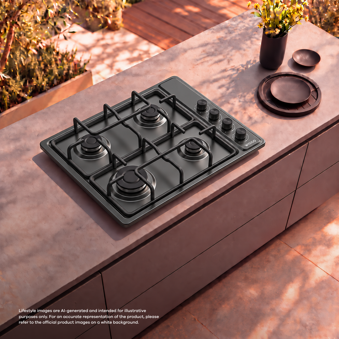A black four-burner gas cooktop is embedded on a pink outdoor kitchen island.