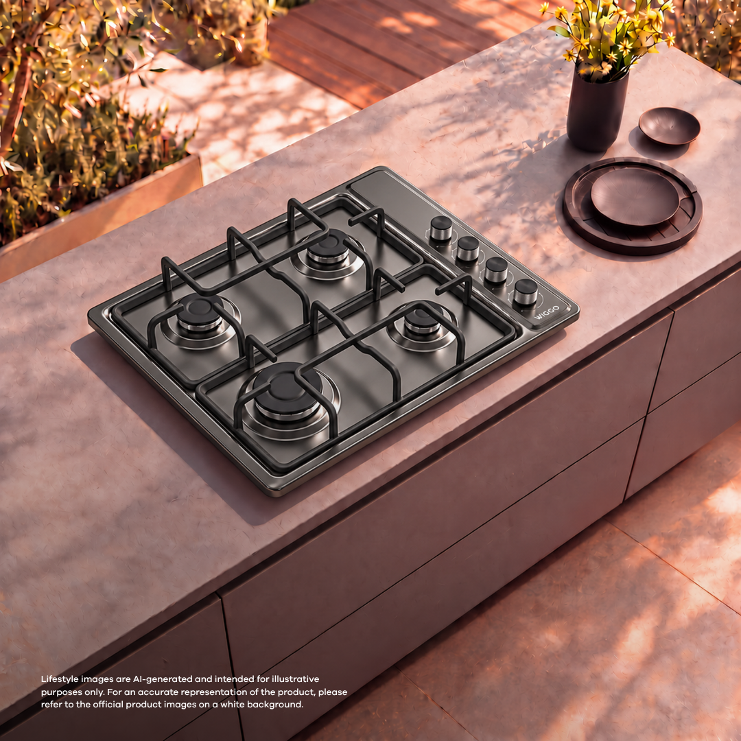 A gas cooktop on an outdoor stone countertop with plates and flowers in a vase nearby.