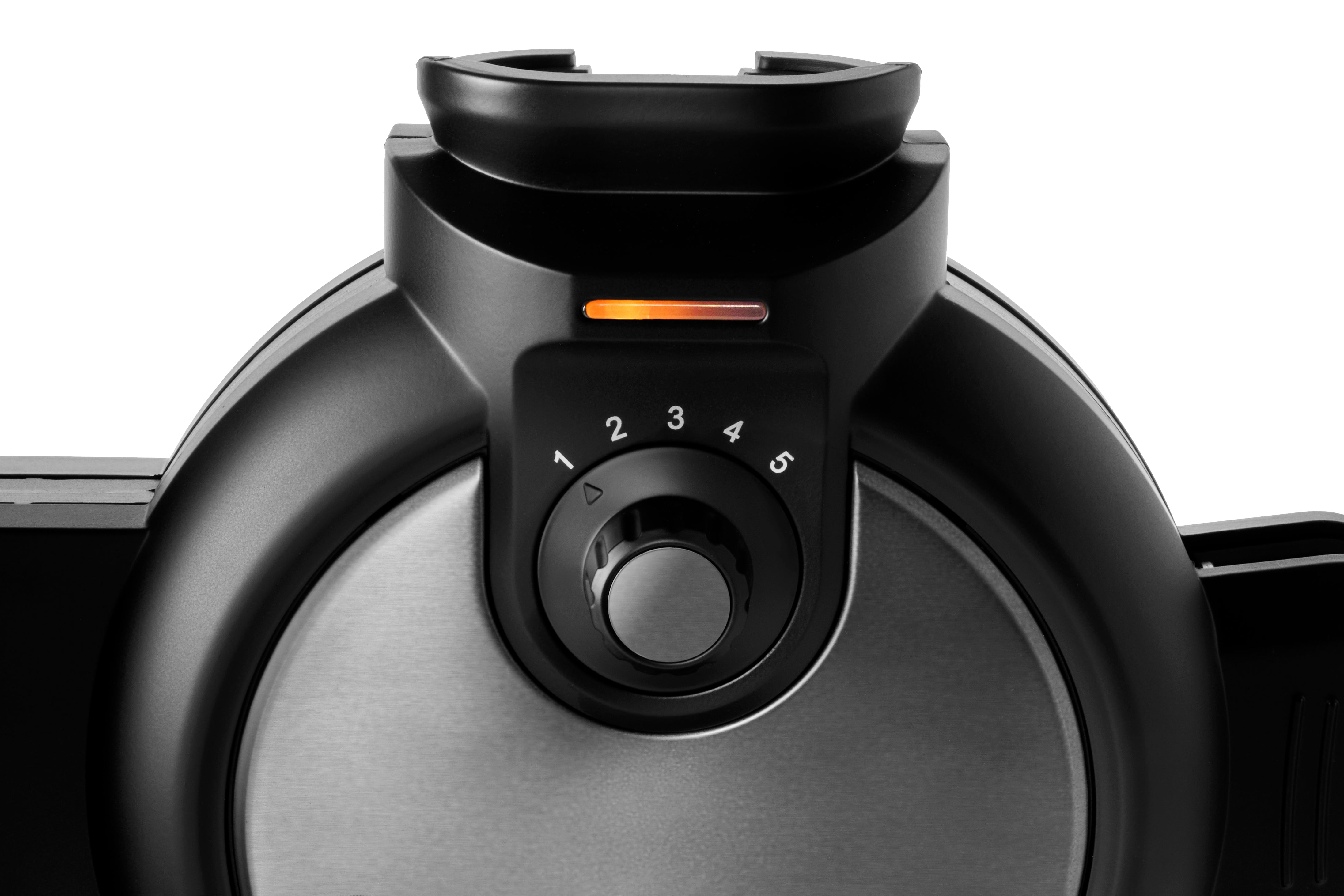 Close-up of a black waffle maker featuring a dial numbered 1 to 5 and an orange indicator light.
