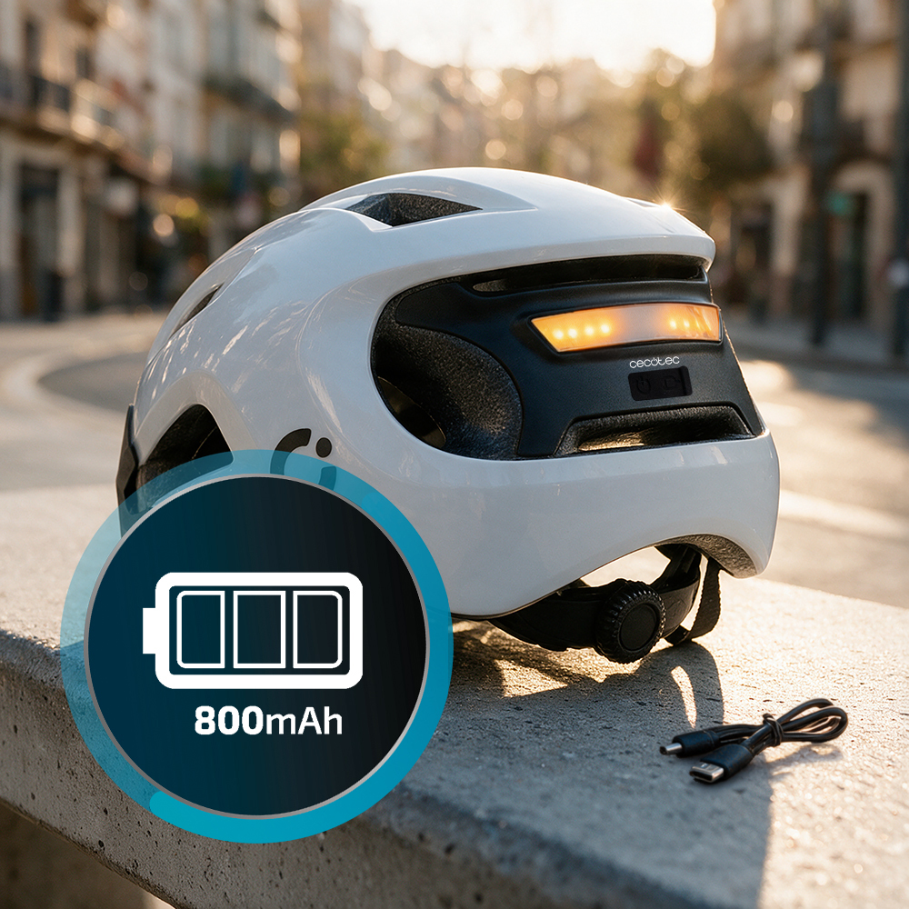 Casco de bicicleta blanco con luz integrada y batería de 800mAh, sobre un muro con cable.