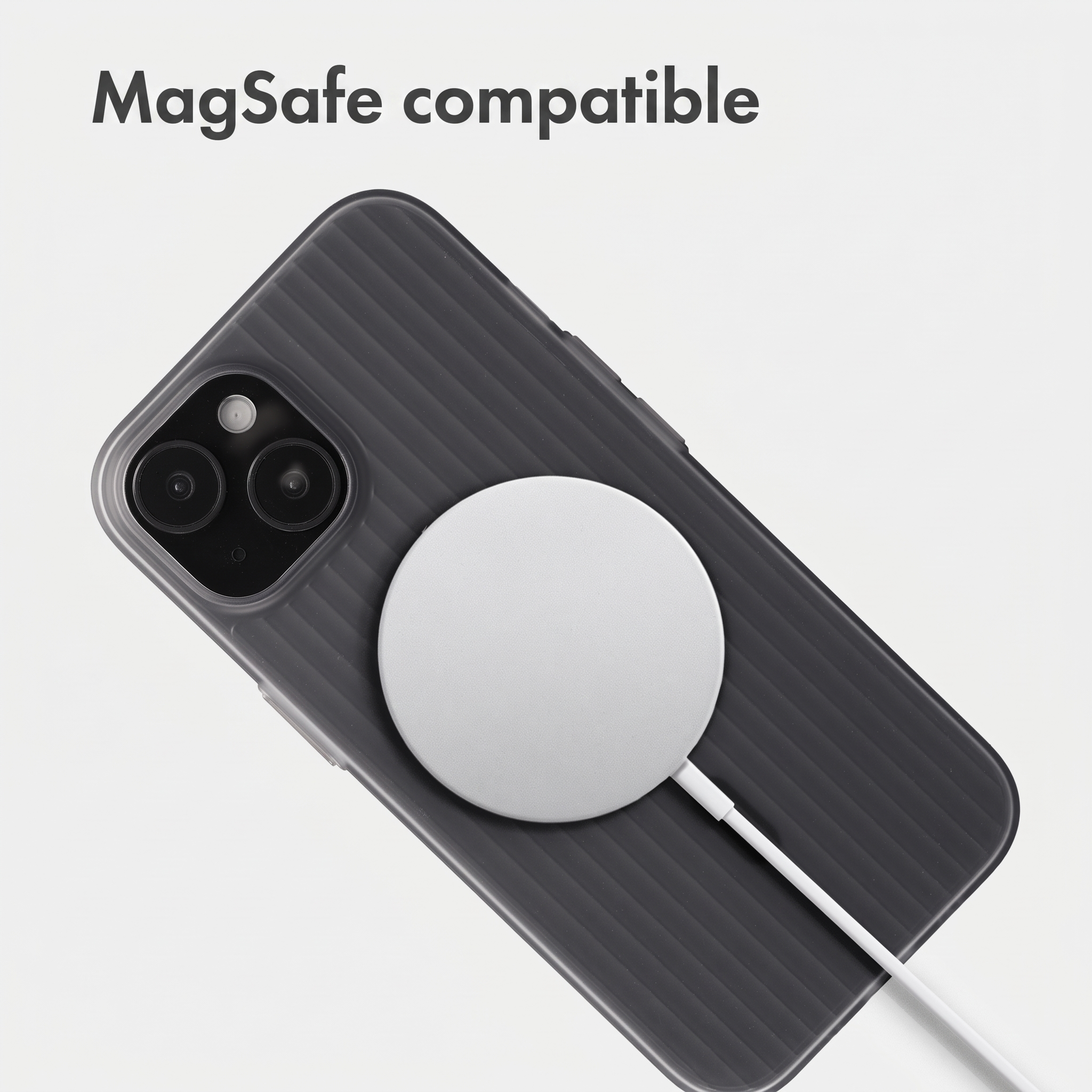 A gray ribbed smartphone in a case with a white MagSafe charger attached.