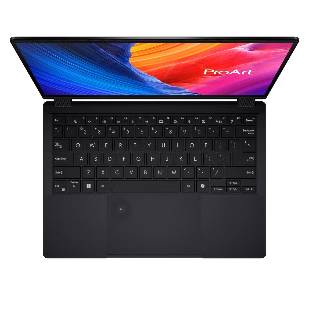 Widok z góry na otwartego czarnego laptopa z kolorową, abstrakcyjną tapetą.