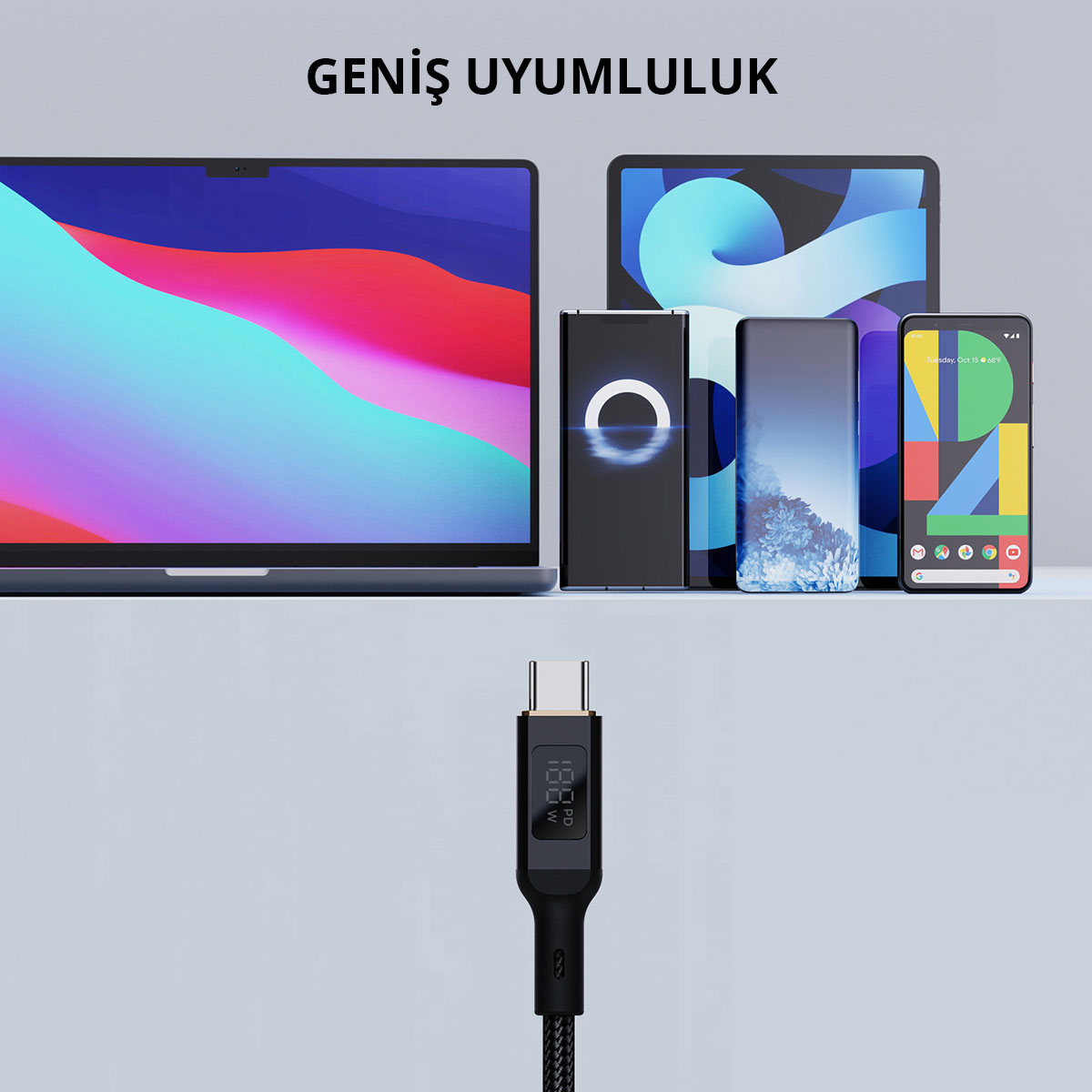 Açık renk arka planda dizüstü bilgisayar, tablet ve akıllı telefonların altında dijital ekrana sahip USB-C kablosu.