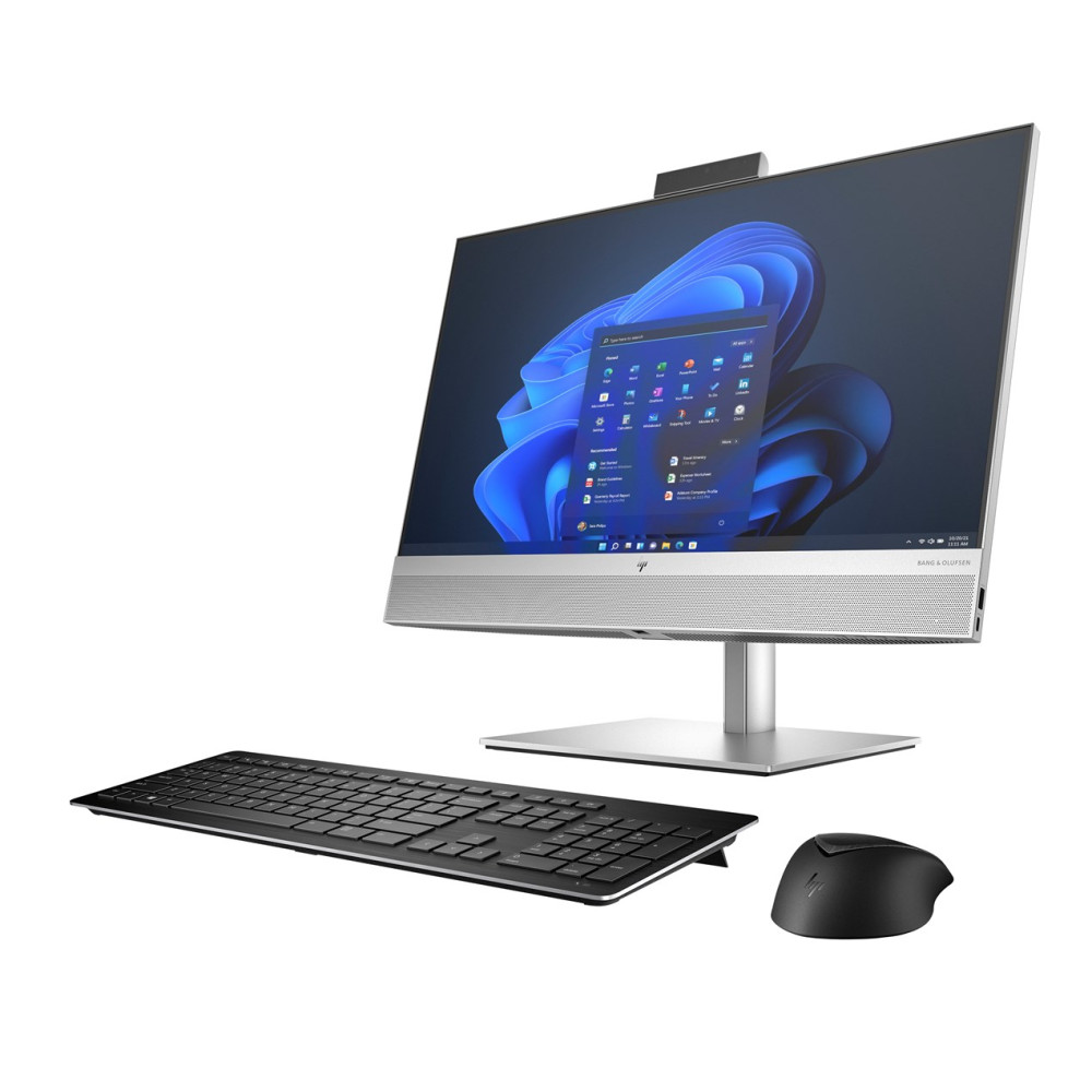 Srebrny komputer stacjonarny all-in-one z niebieską tapetą systemu Windows, czarną klawiaturą i myszką.