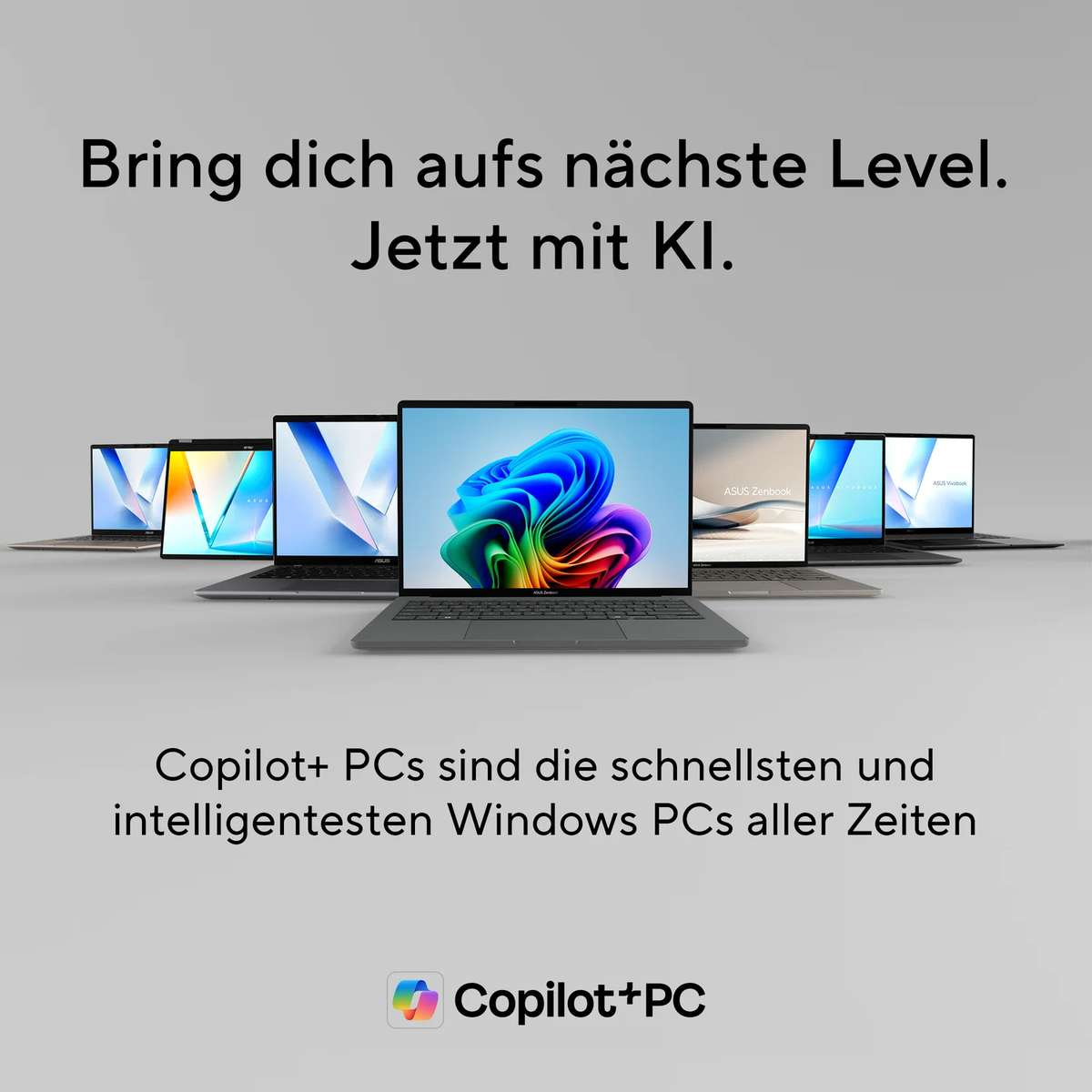 Mehrere ASUS-Laptops mit farbenfrohen Bildschirmen stehen aufgereiht auf einem grauen Hintergrund mit Text.