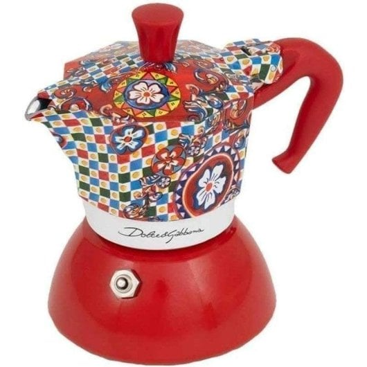 Una colorata moka con base e manico rossi, decorata con motivi floreali e geometrici.
