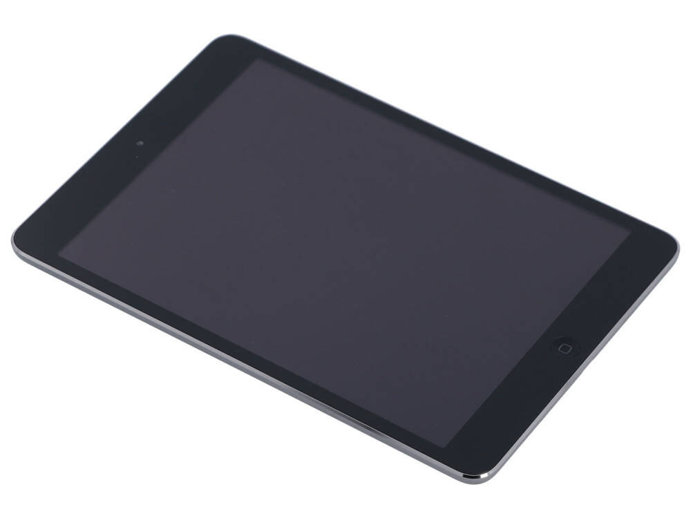 Czarny tablet leży ukośnie na białej powierzchni z wyłączonym ekranem.