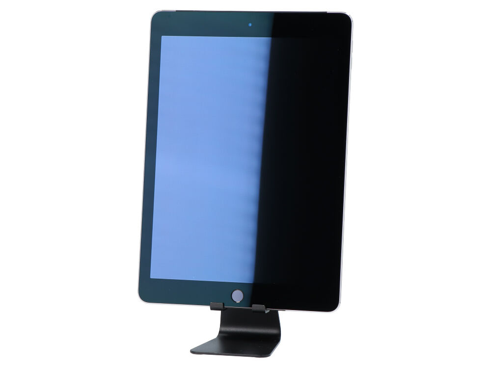 Czarny tablet stoi pionowo na metalowej podstawce na białym tle.