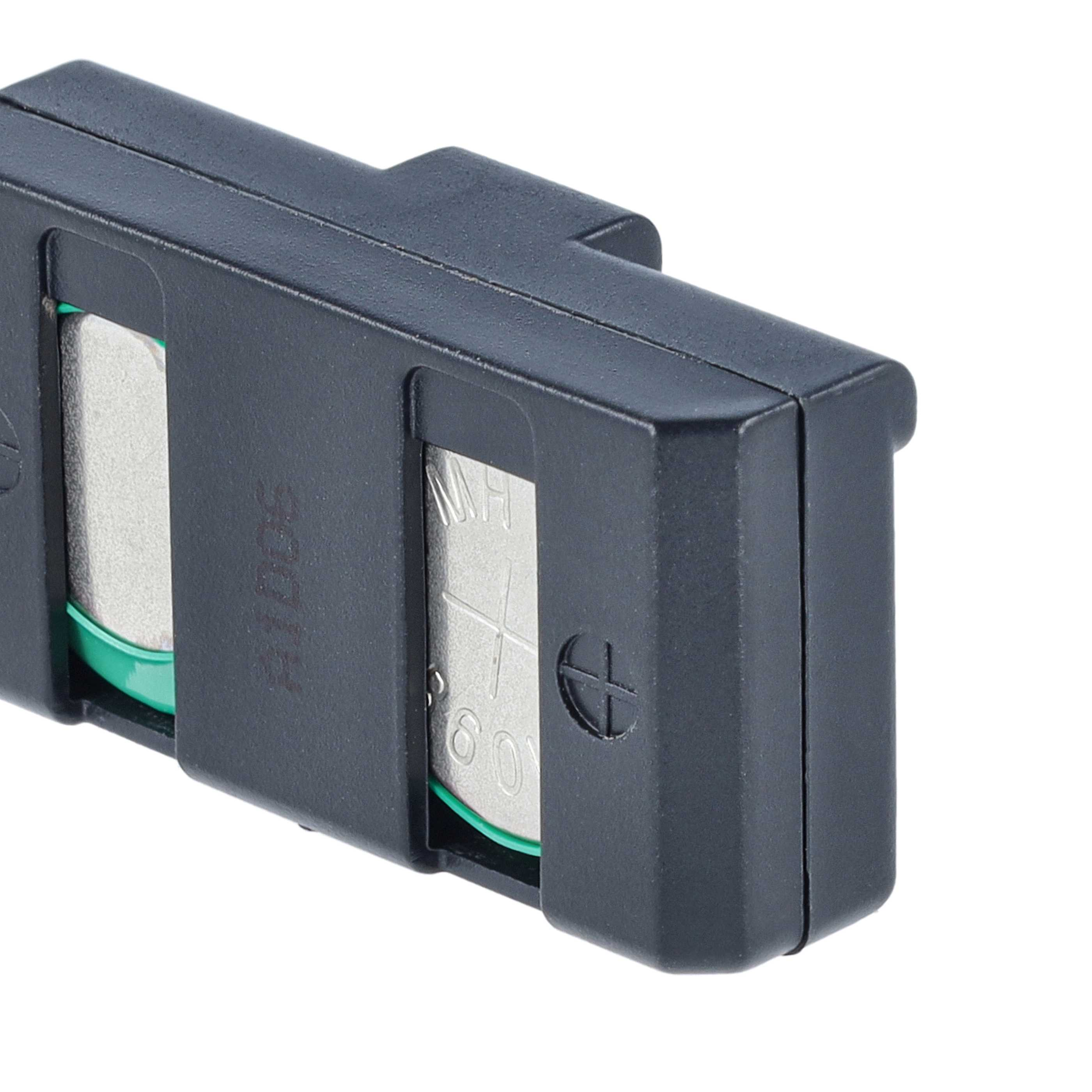 Ein schwarzes Kunststoffgehäuse mit zwei silbernen Knopfzellenbatterien und grünen Dichtungen.