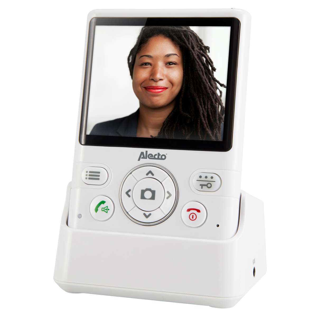 Ein weißes Alecto-Videotelefon auf einer Ladestation zeigt das lächelnde Gesicht einer Frau mit Dreadlocks.
