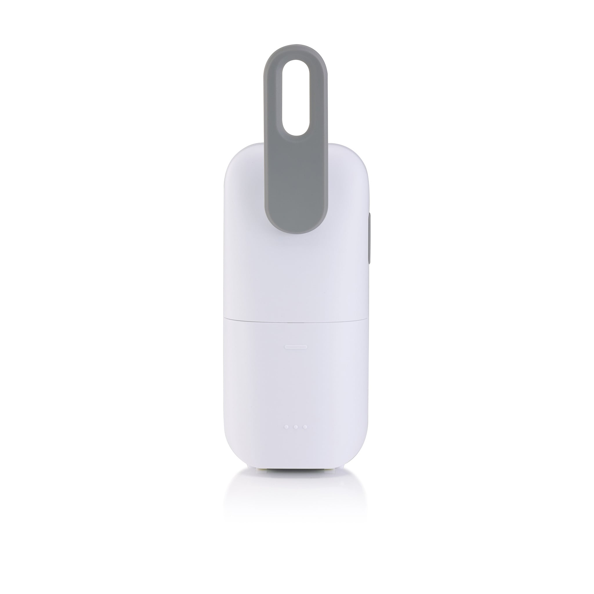 A white portable device with a grey handle and LED indicator lights on a white surface.