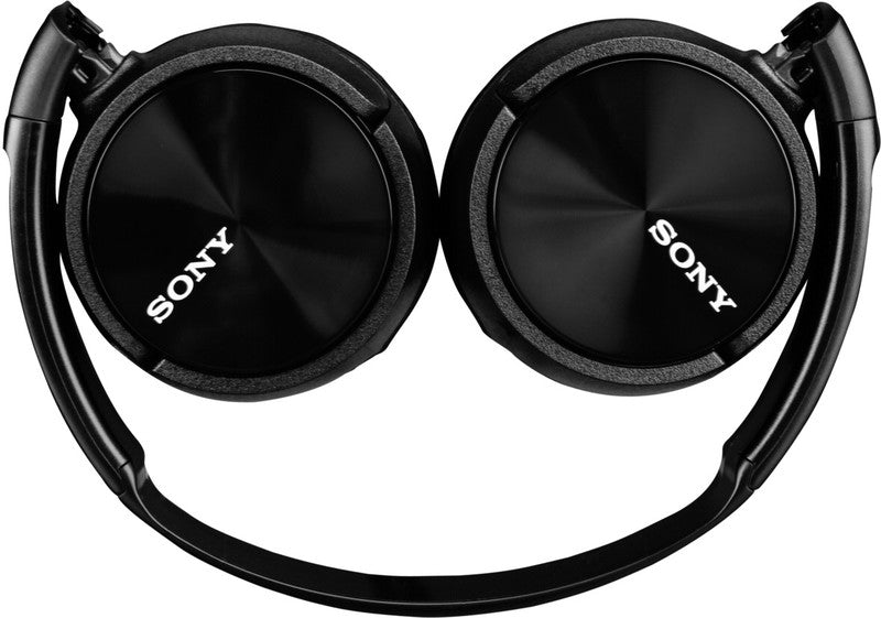 Black Sony headphones lie flat with the Sony logo on the ear cups.