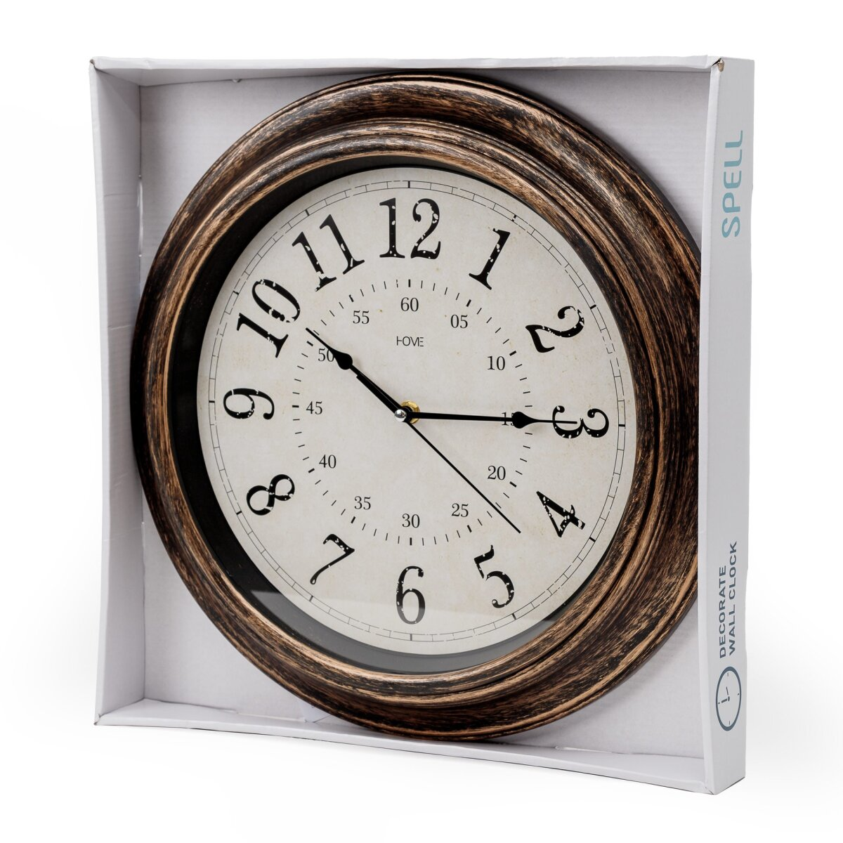 Eine runde Wanduhr mit dunklem, antikem Rahmen in einer offenen weißen Pappschachtel.