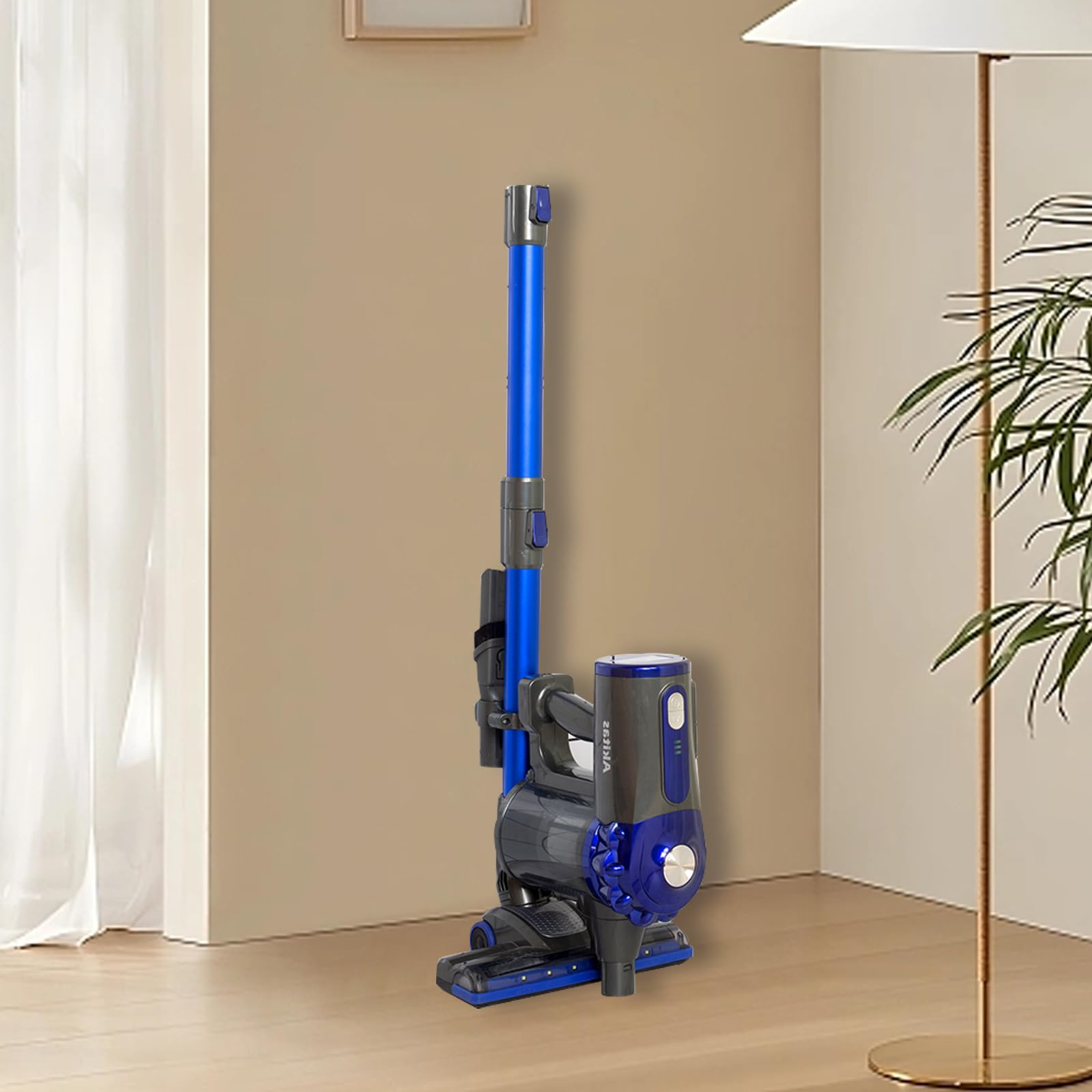 Ein blauer und grauer kabelloser Staubsauger steht auf einem Holzboden in einem Raum mit Lampe.