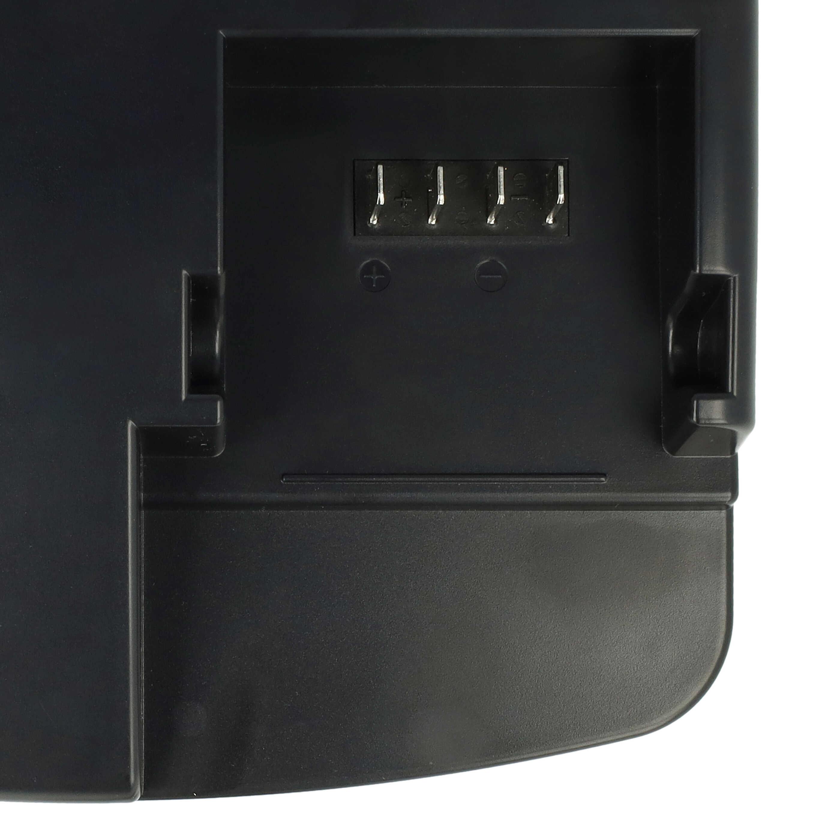 Nahaufnahme einer schwarzen Batteriebasis aus Kunststoff mit vier Metallkontakten und Plus-Minus-Symbolen.