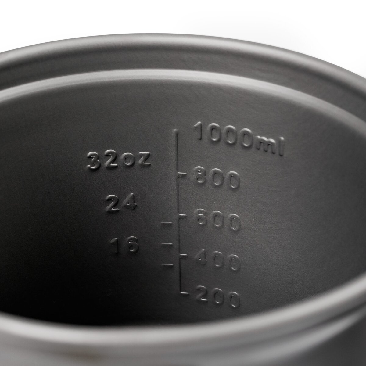 Innenansicht eines dunklen Metalltopfs mit geprägten Messmarkierungen bis zu 1000 ml und 32 oz.