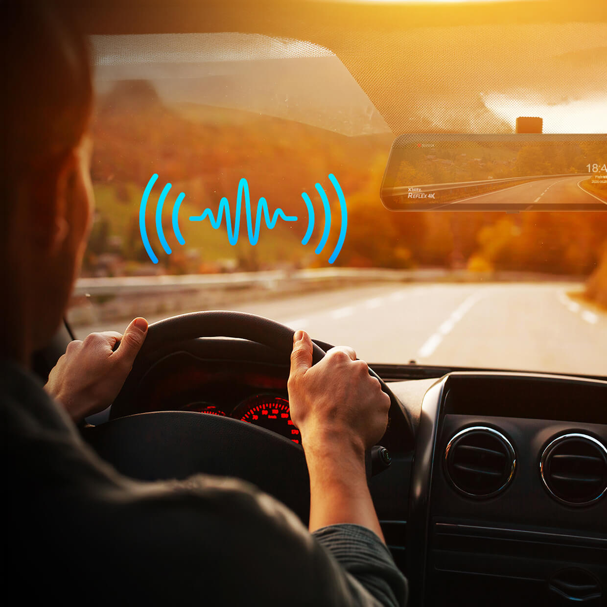 Ein Fahrer hält das Lenkrad eines Autos, während eine blaue Tonwelle auf der Windschutzscheibe erscheint.