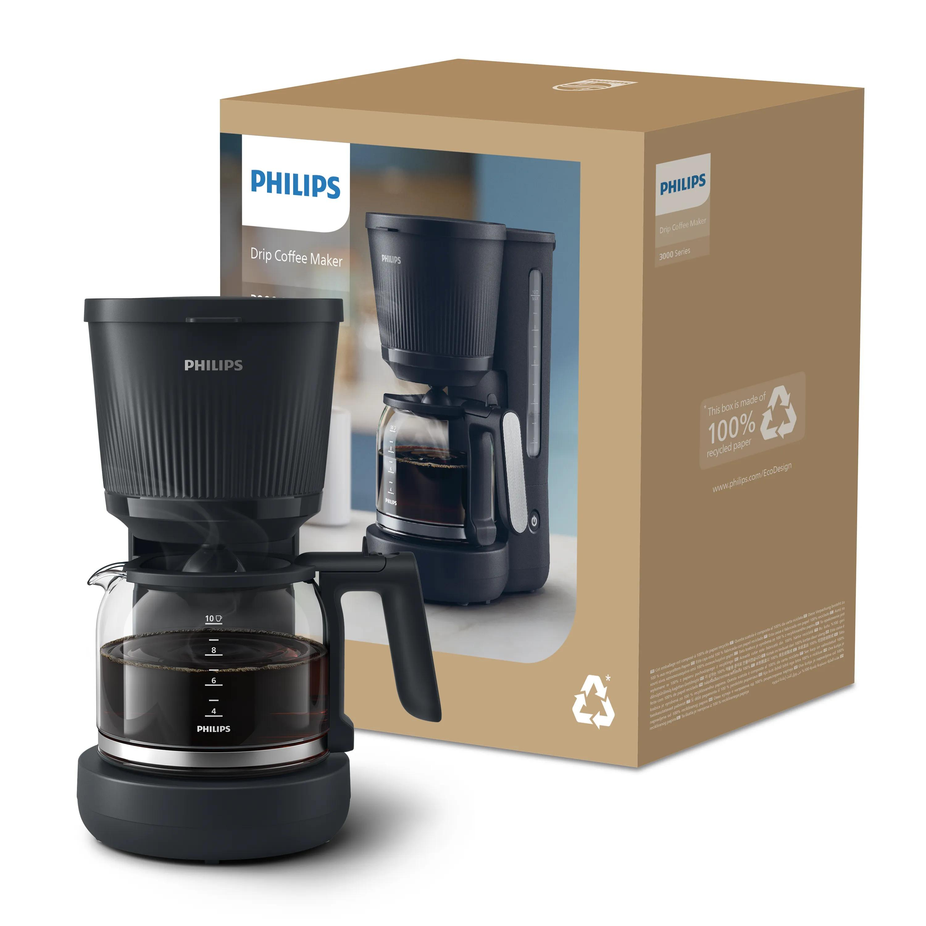 A black Philips drip coffee maker stands in front of its recyclable packaging box.