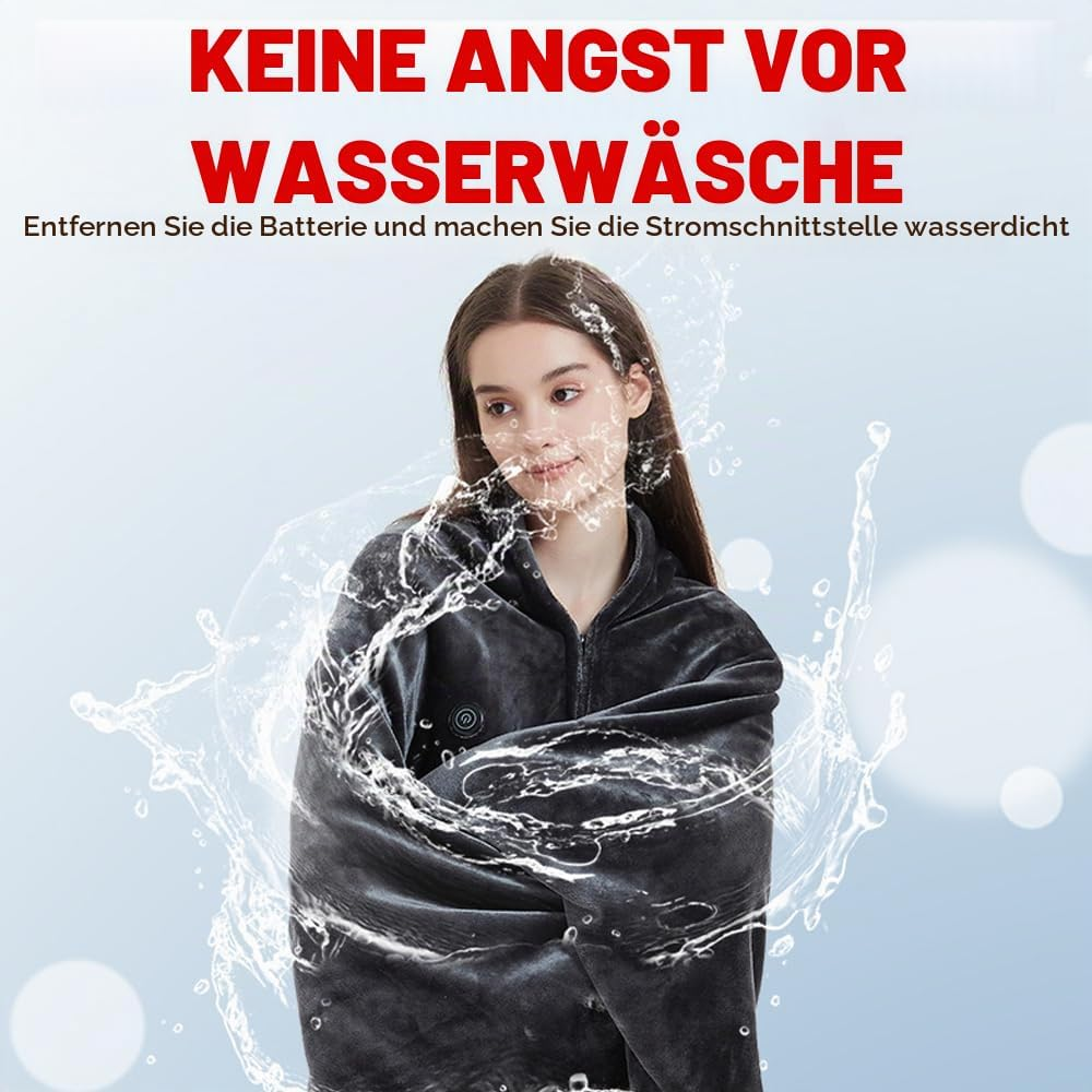 Eine Frau in einer grauen beheizbaren Weste, umgeben von einem kreisförmigen Wasserspritzer.