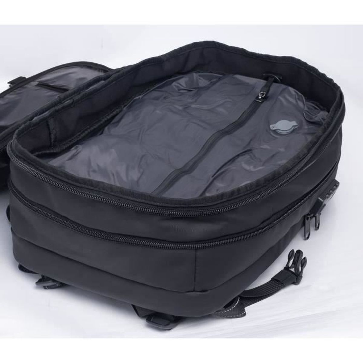 Ein offener, schwarzer Reiserucksack mit Reißverschlüssen und Riemen auf hellem Hintergrund.