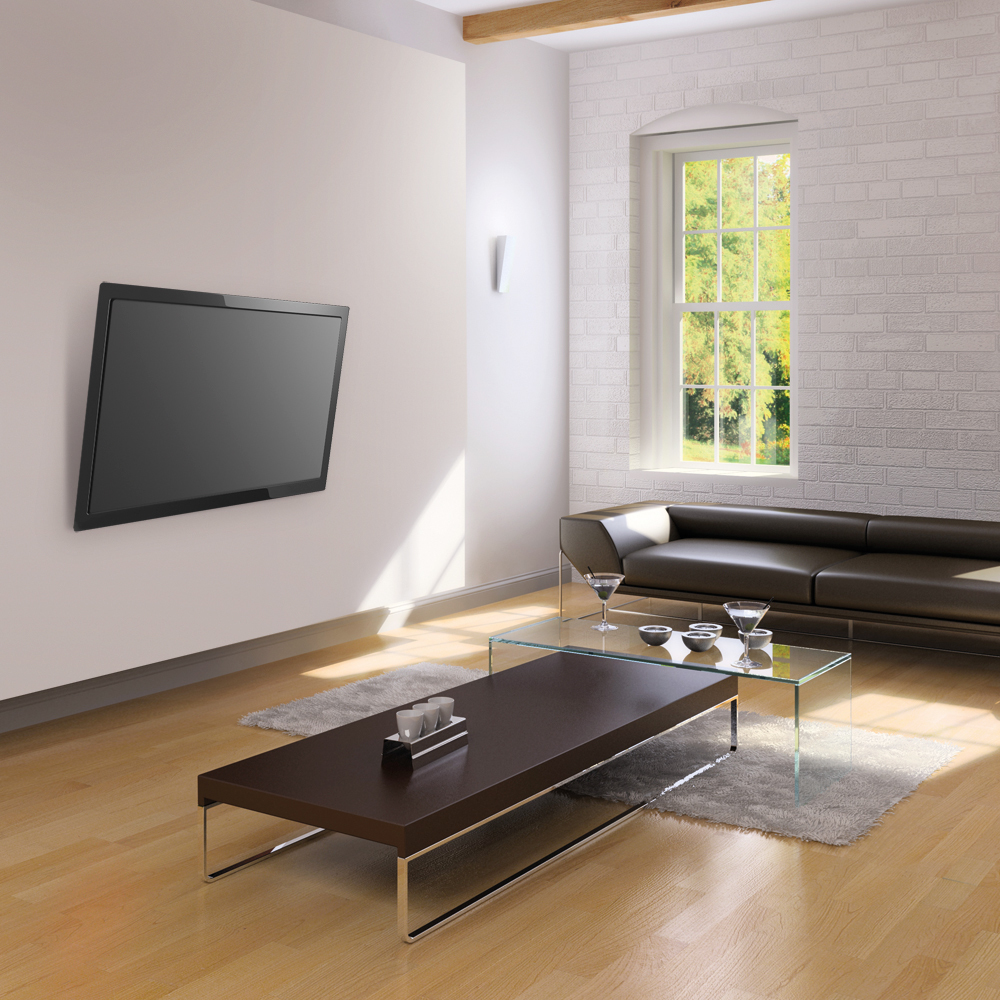 Modern living room with black sofa, flat screen TV, glass table, and hardwood floor against a white wall.