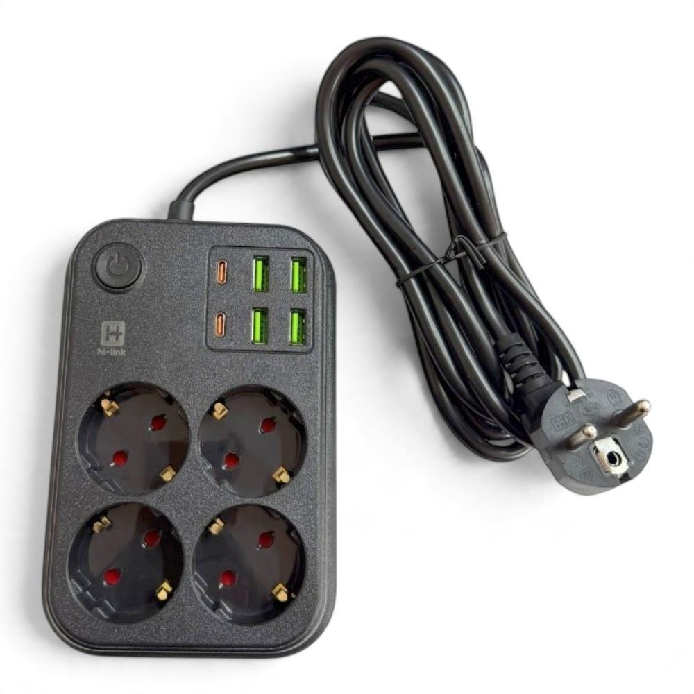 Beyaz zemin üzerinde dört prizli, altı USB portlu, güç düğmeli ve sarılmış kablolu siyah uzatma kablosu.