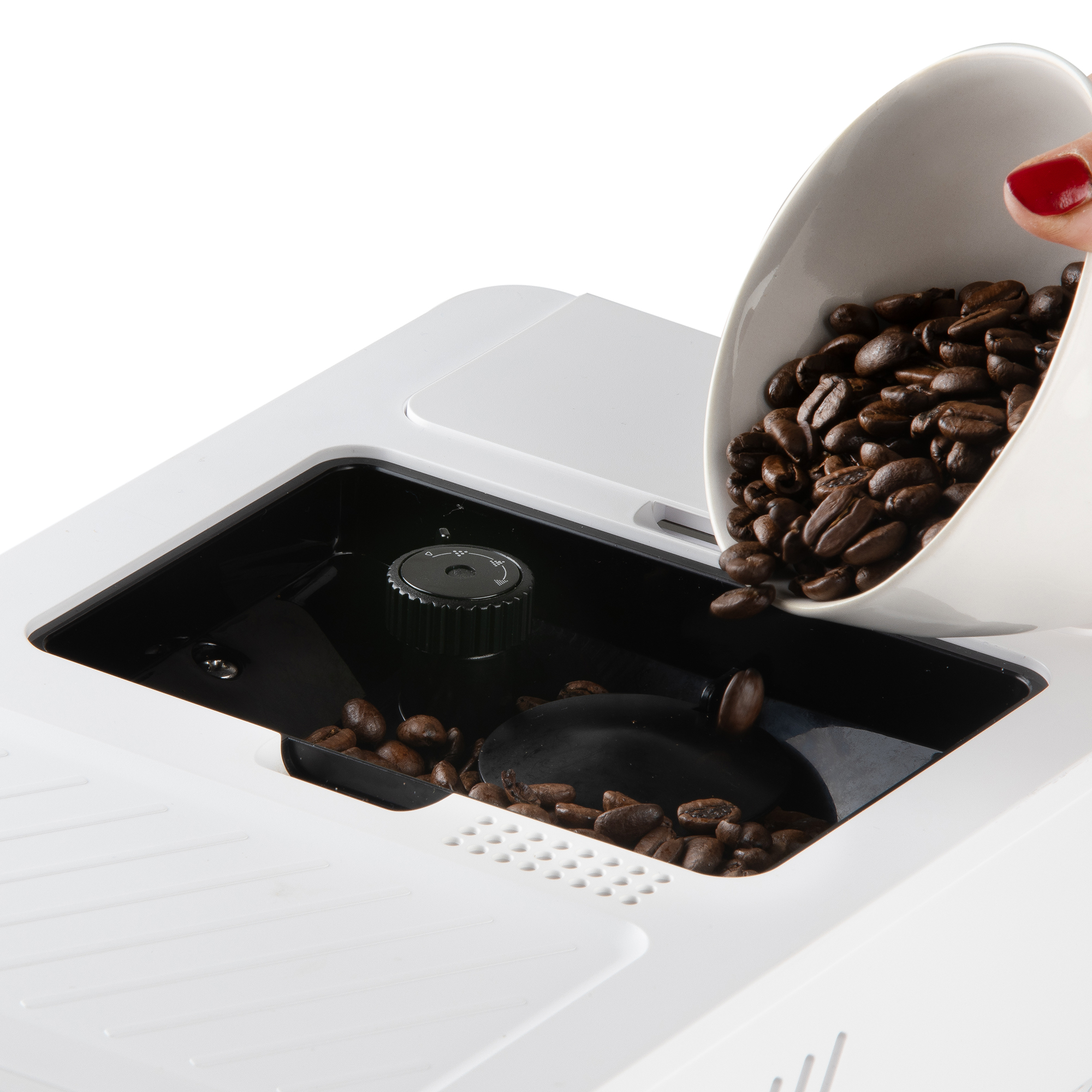 Een hand met rode nagellak giet koffiebonen uit een witte kom in een koffiezetapparaat.