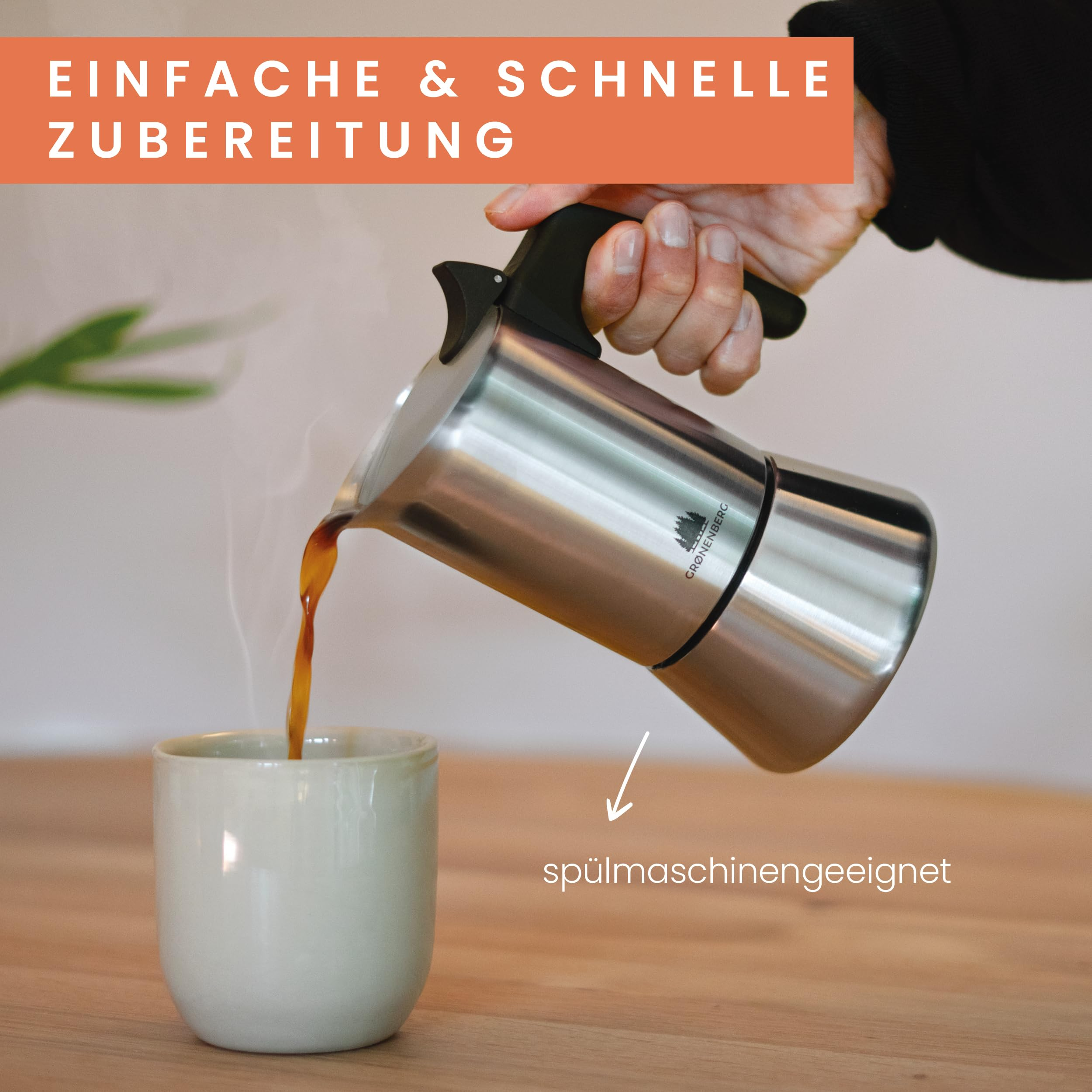 Une main verse du café d'une cafetière en inox dans une tasse claire sur du bois.