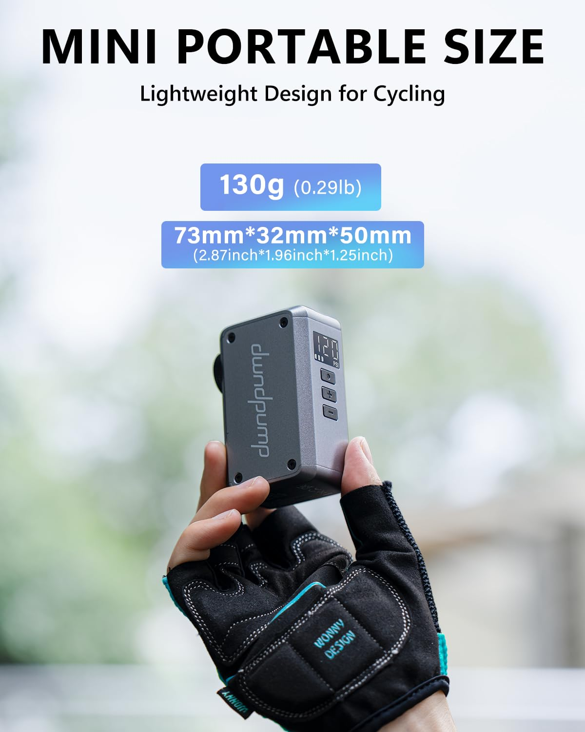 Eine Hand in einem Fahrradhandschuh hält eine kompakte, graue Mini-Luftpumpe vor hellem Hintergrund.