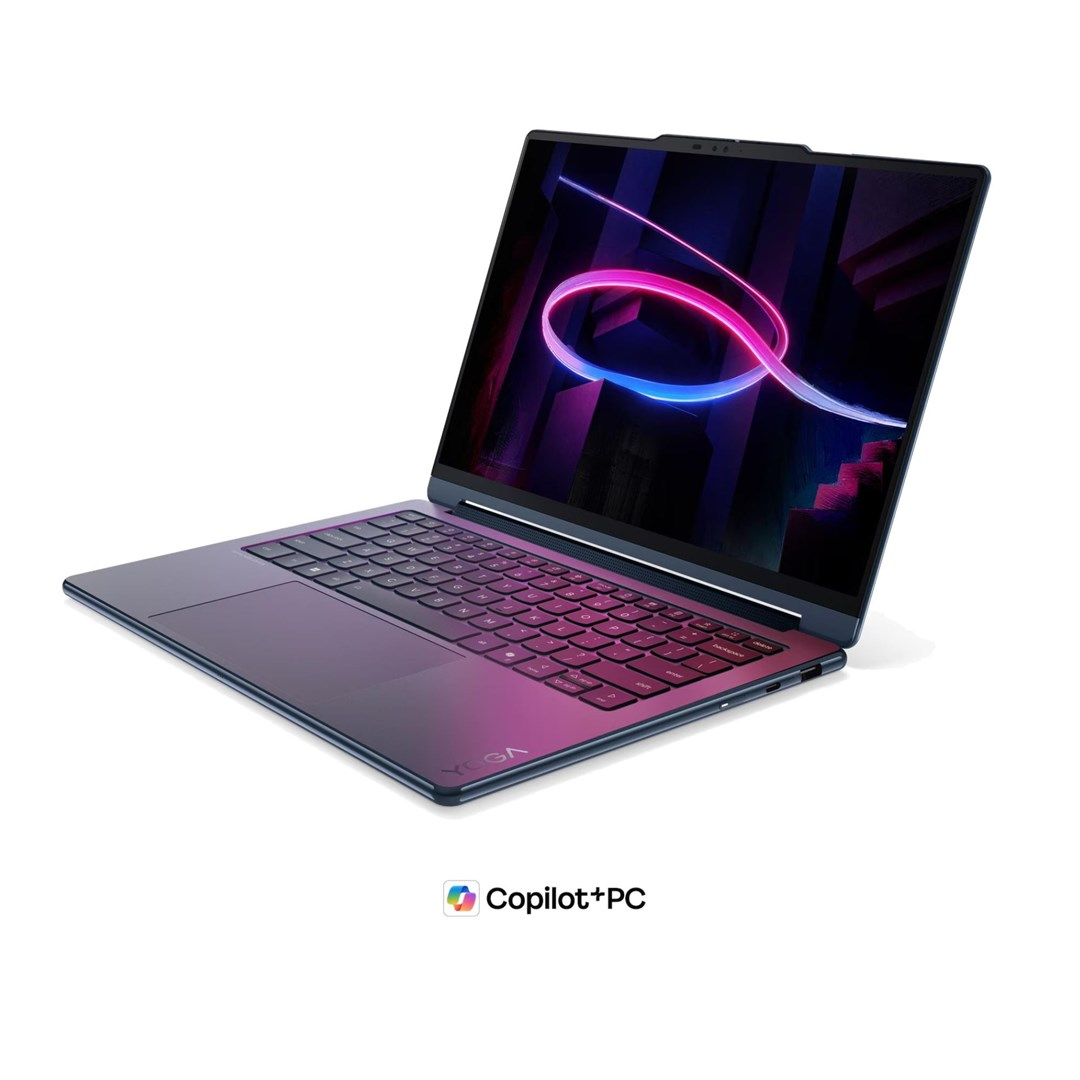 Niebieski laptop z różowym gradientem, świecącym ekranem i logo YOGA na białej powierzchni.
