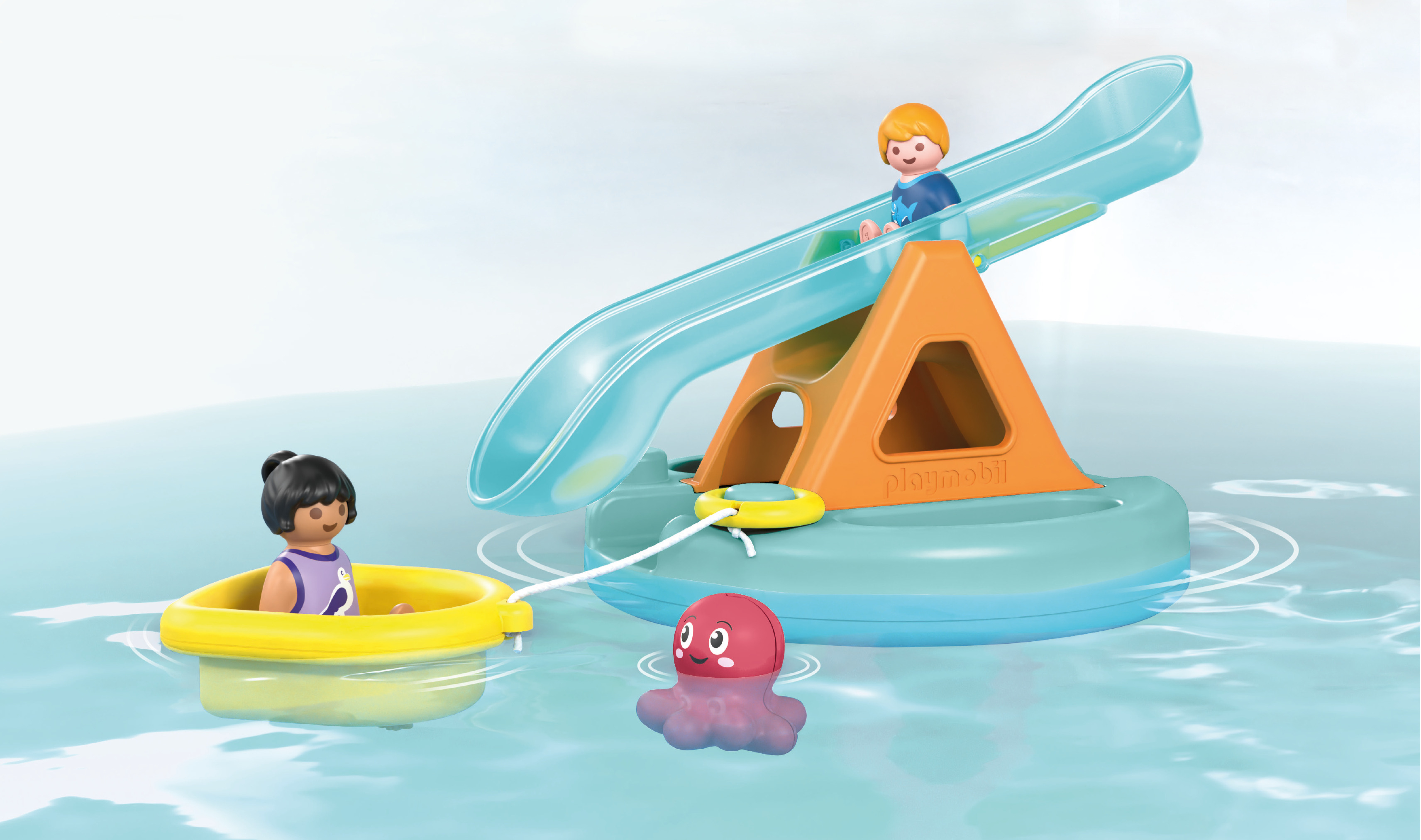 Playmobil figures on a floating water slide and a small boat with a red octopus toy in the water.