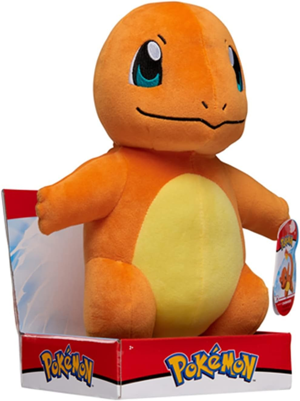 Peluche de Charmander sentado en una caja roja de Pokémon.
