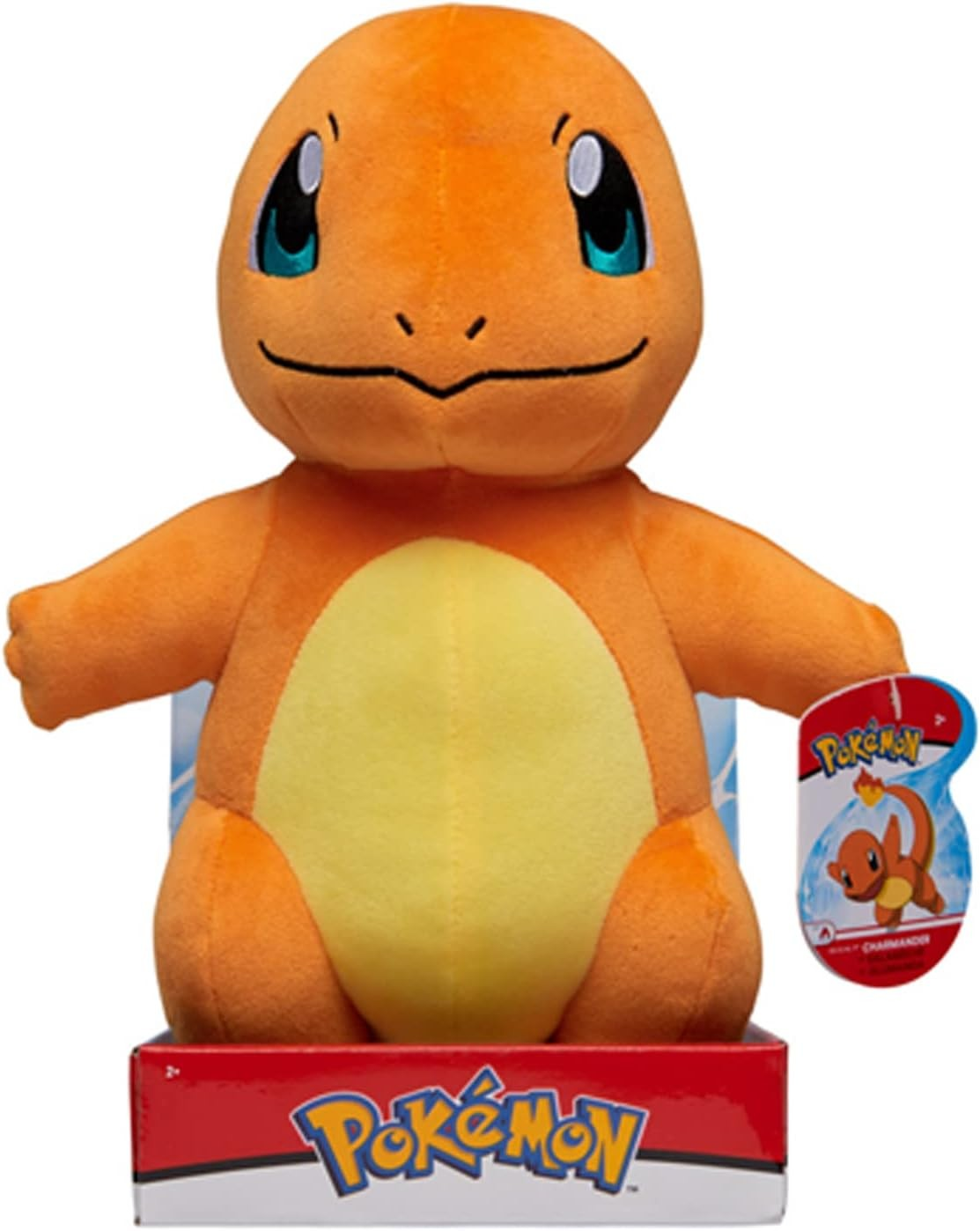 Un peluche naranja de Charmander sentado en una caja de Pokemon.