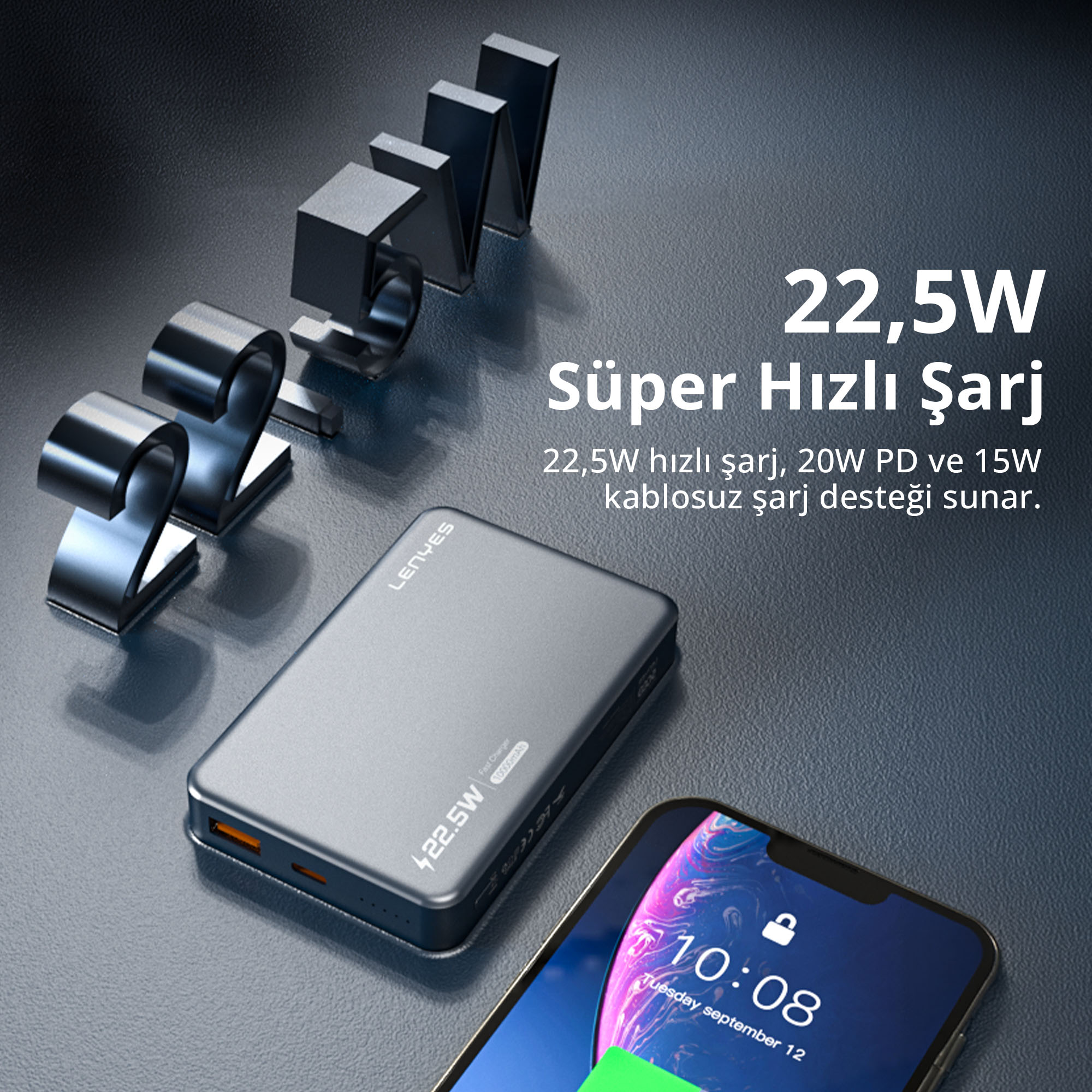 Koyu zemin üzerinde yazı ve rakamların olduğu gri powerbank ile akıllı telefon.