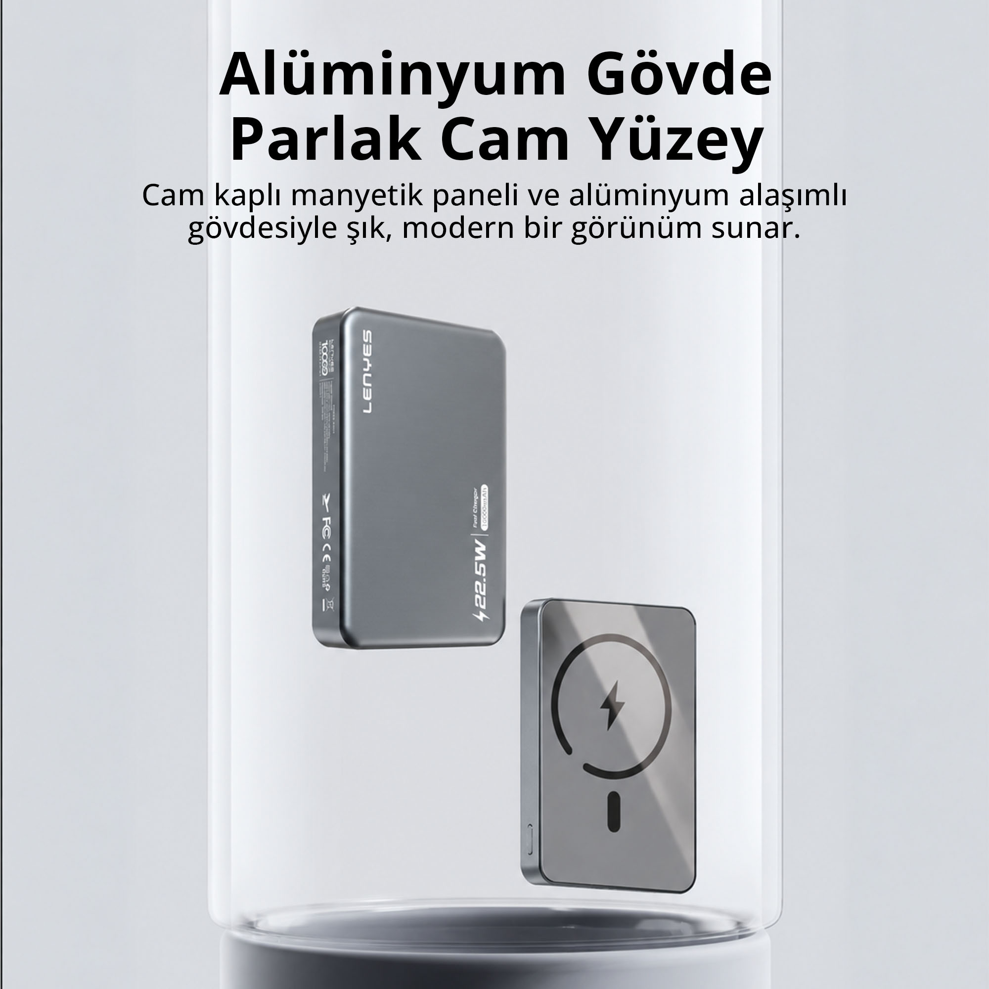 Alüminyum gövdeli ve cam kaplı manyetik panelli gri taşınabilir şarj cihazı açık arka planda.