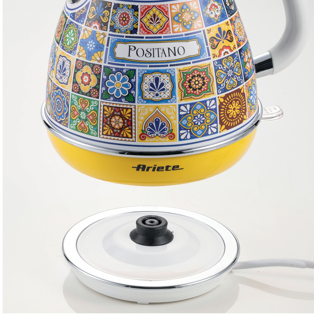 Colorful Ariete Positano electric kettle with vibrant tile patterns and a yellow base above its power stand.