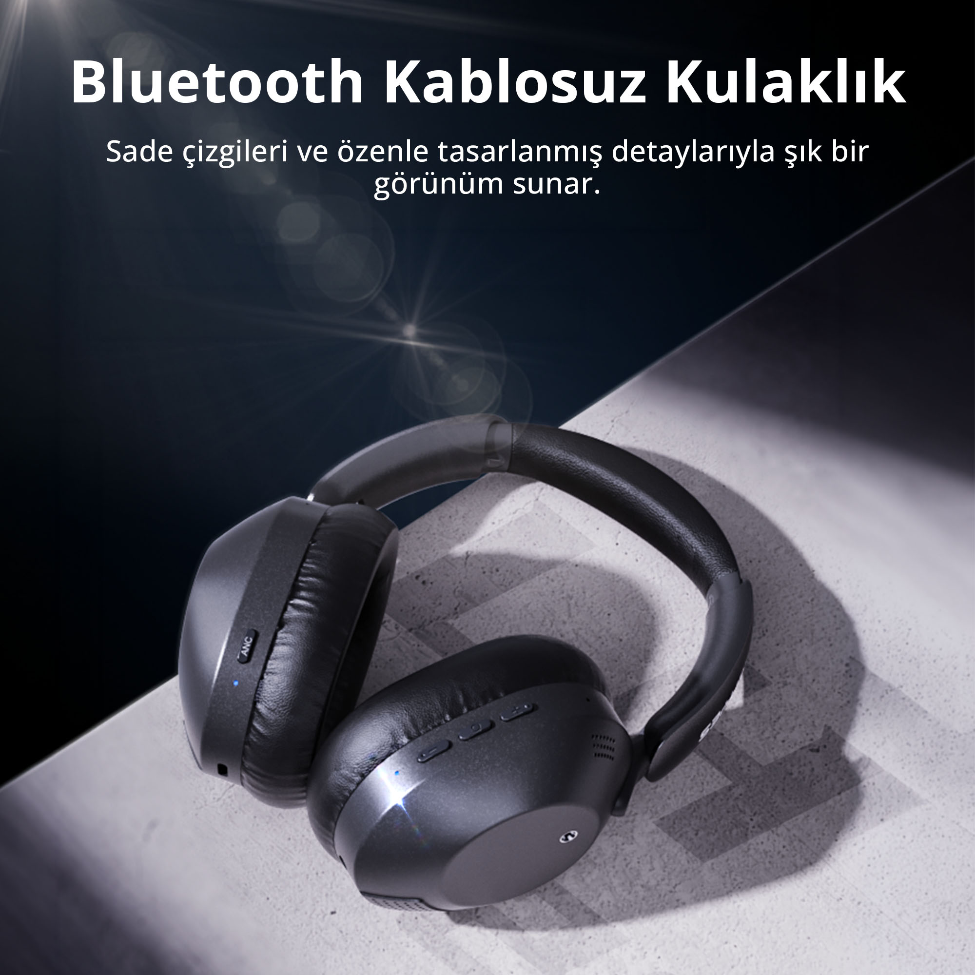Işık efektli arka planda, açık renk zemin üzerinde siyah Bluetooth kulaklık.