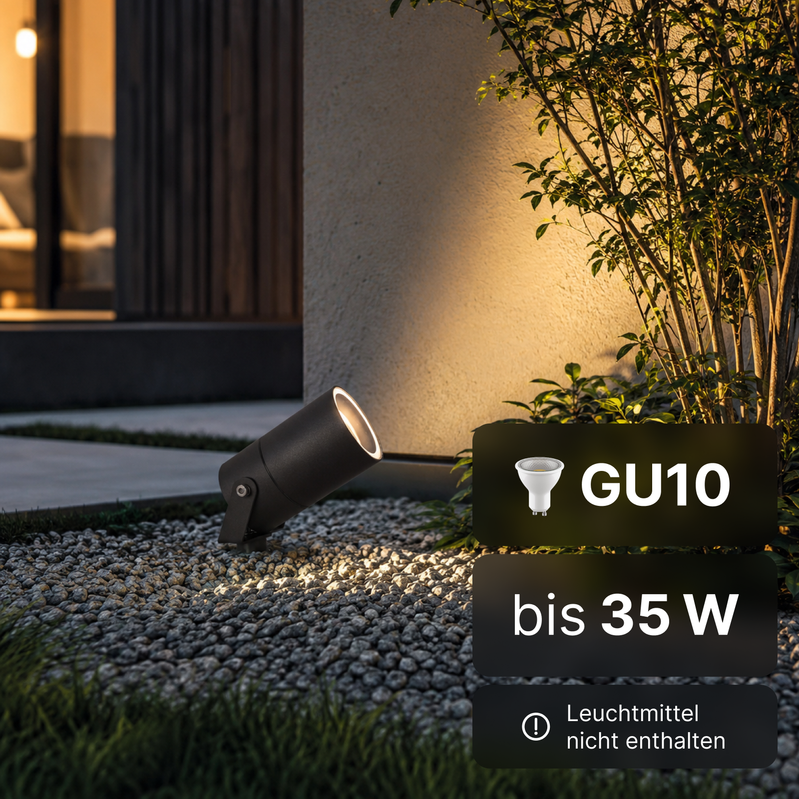 Schwarzer LED-Gartenstrahler auf Kiesboden beleuchtet eine Wand. Textanzeige GU10 bis 35 W.
