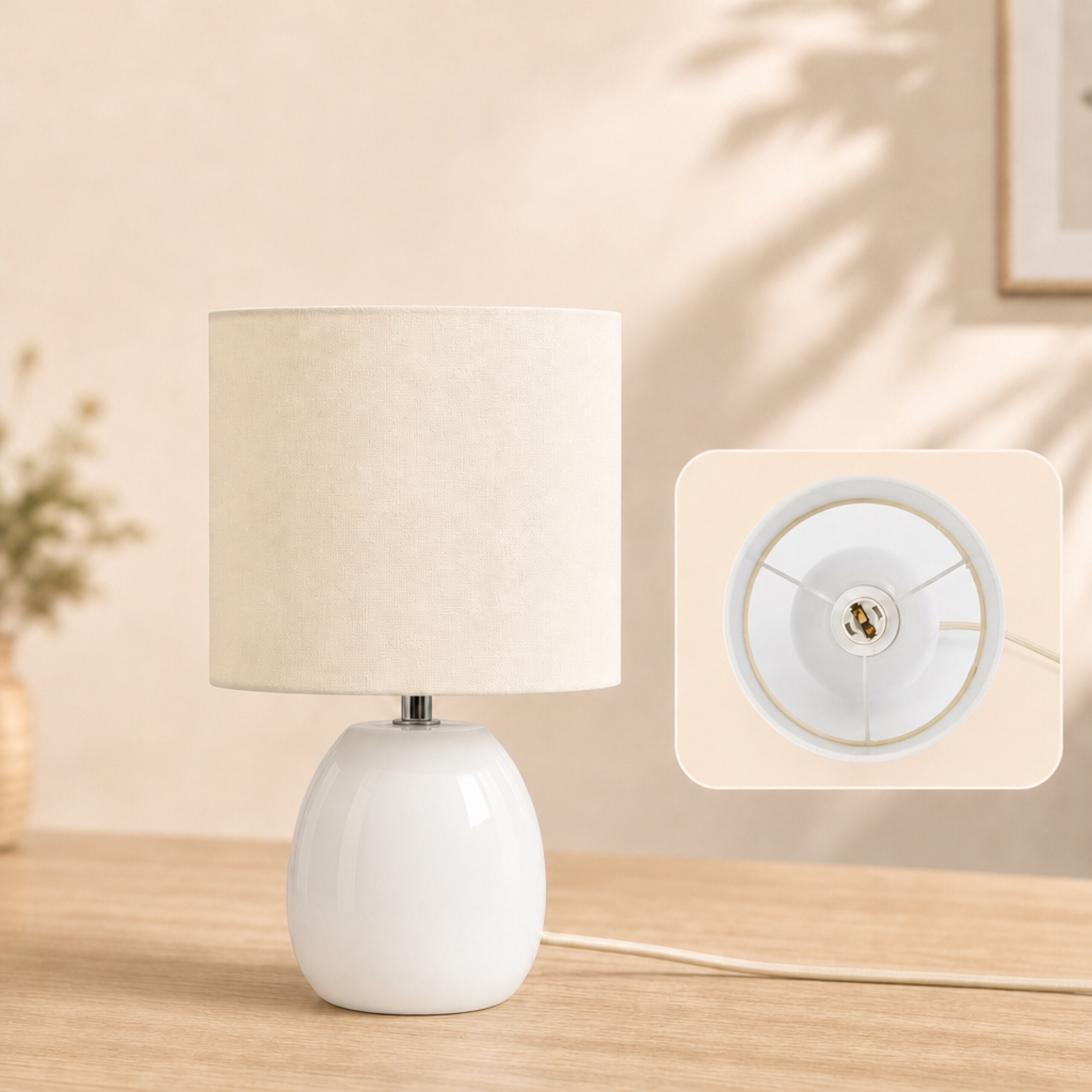 Eine kleine weiße Tischlampe mit zylindrischem Schirm auf Holzoberfläche; Detailansicht zeigt die Lampenfassung.