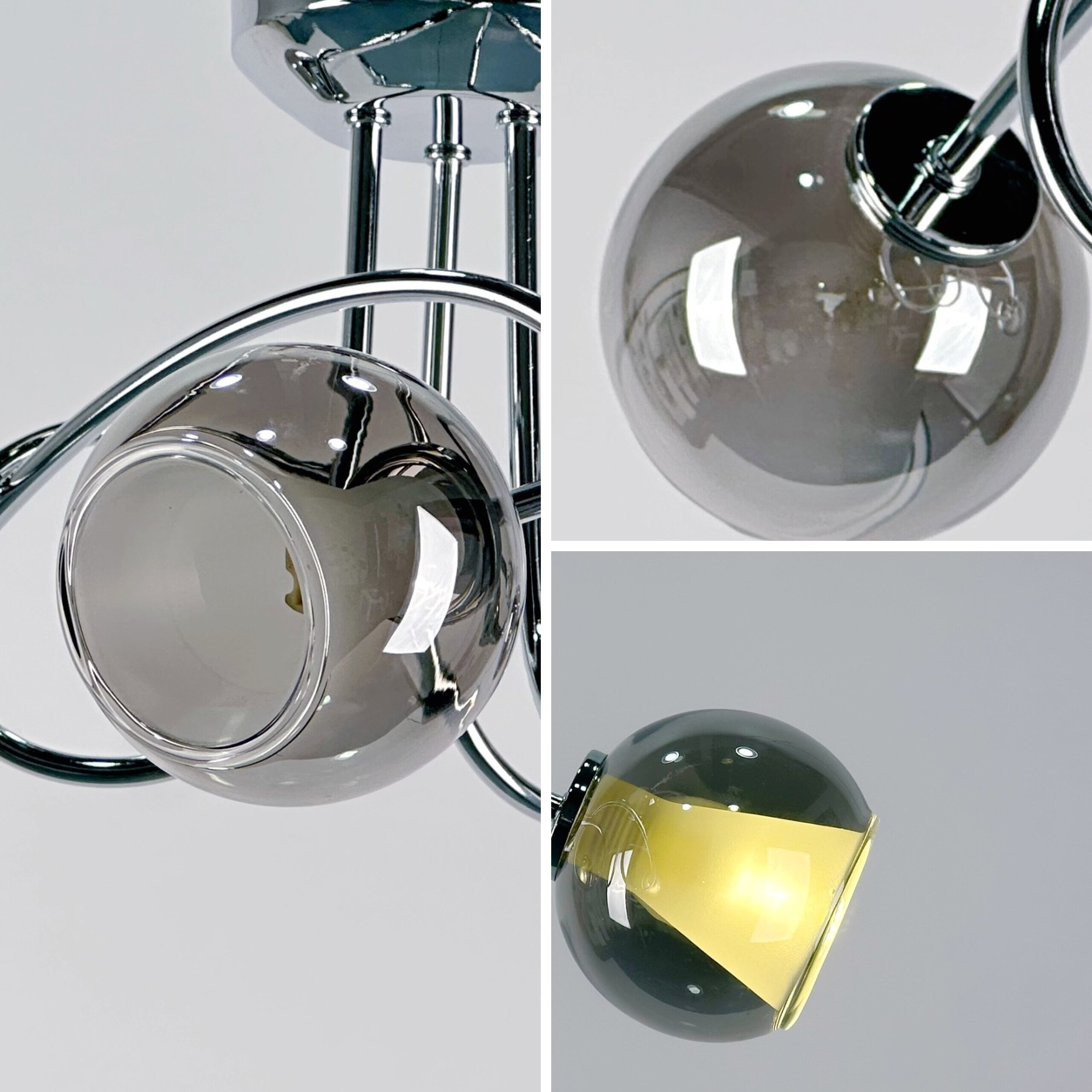 Moderne Deckenlampe mit verchromtem Metallgestell und rauchgrauen Glaskugeln, teilweise beleuchtet.
