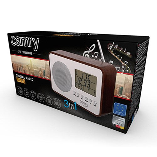 Verpackung eines Camry Digitalradios mit Holzrahmen und weißem Frontpanel, digitalem Display und Lautsprecher.
