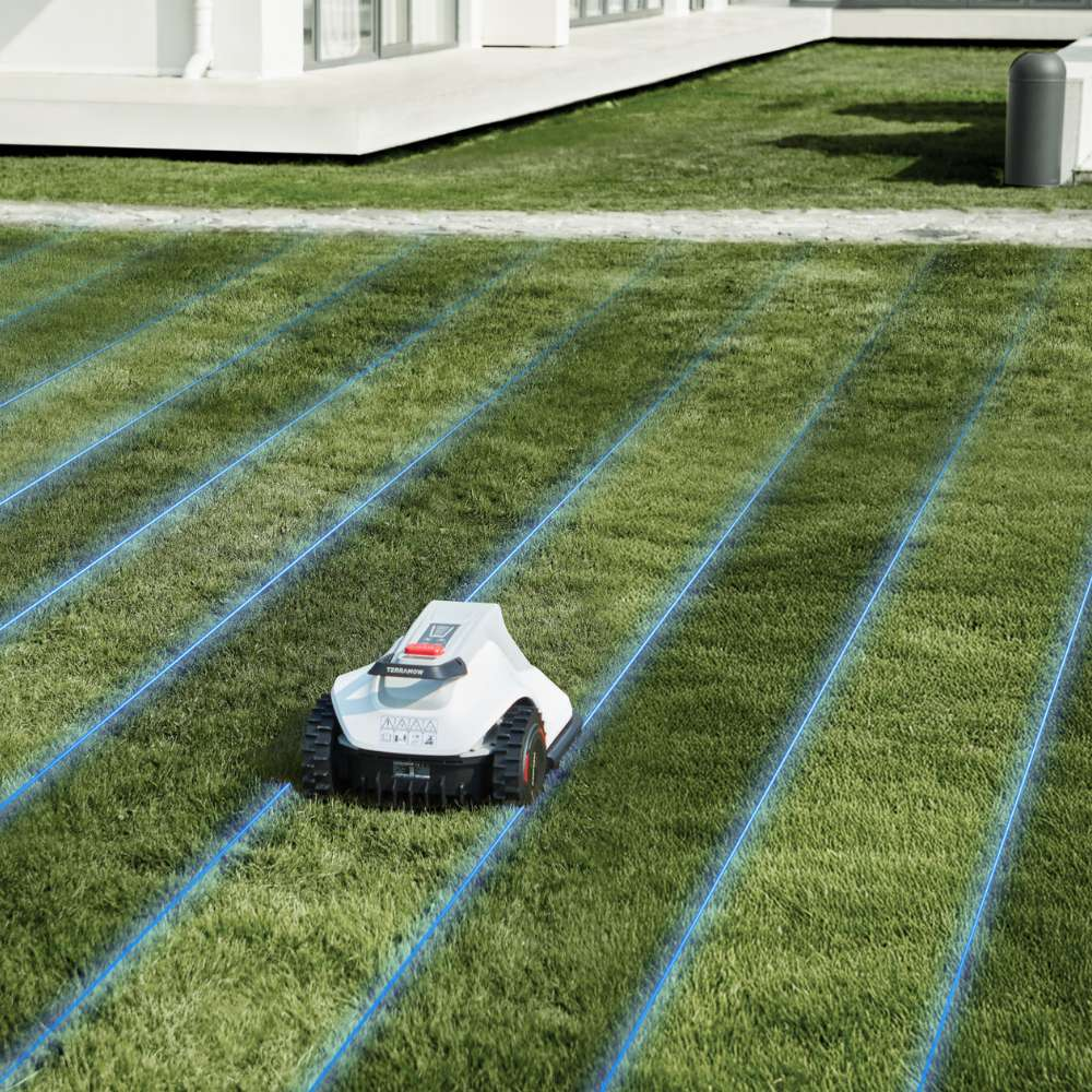 A white robotic lawnmower cuts green grass on a sunny day, guided by blue virtual lines overlaid on the lawn.