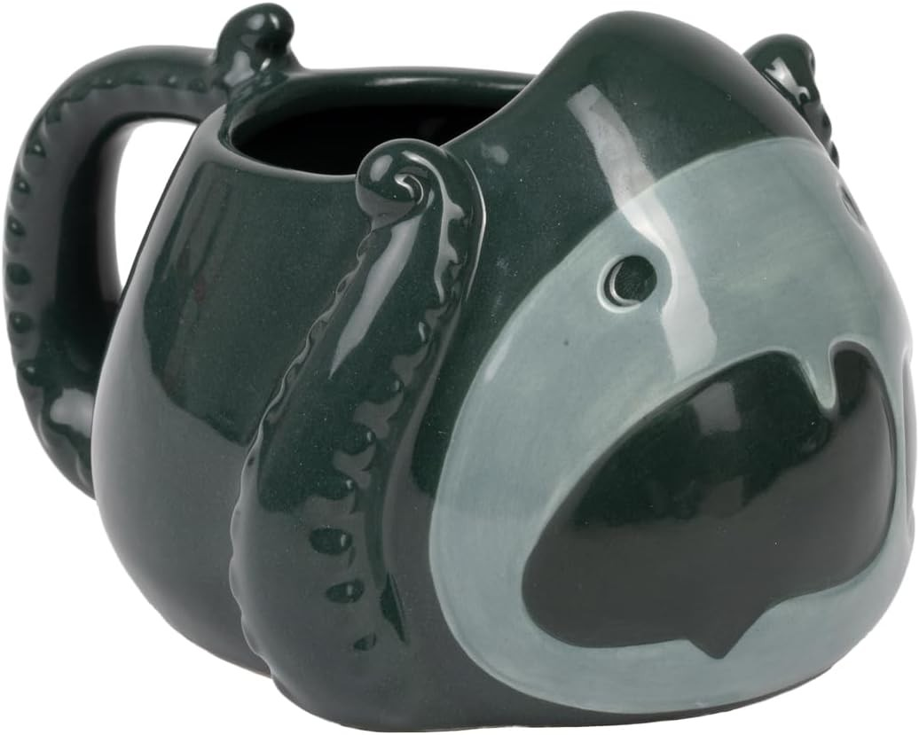 Una taza de cerámica verde oscura con forma de criatura con tentáculos, grandes ojos y boca abierta.