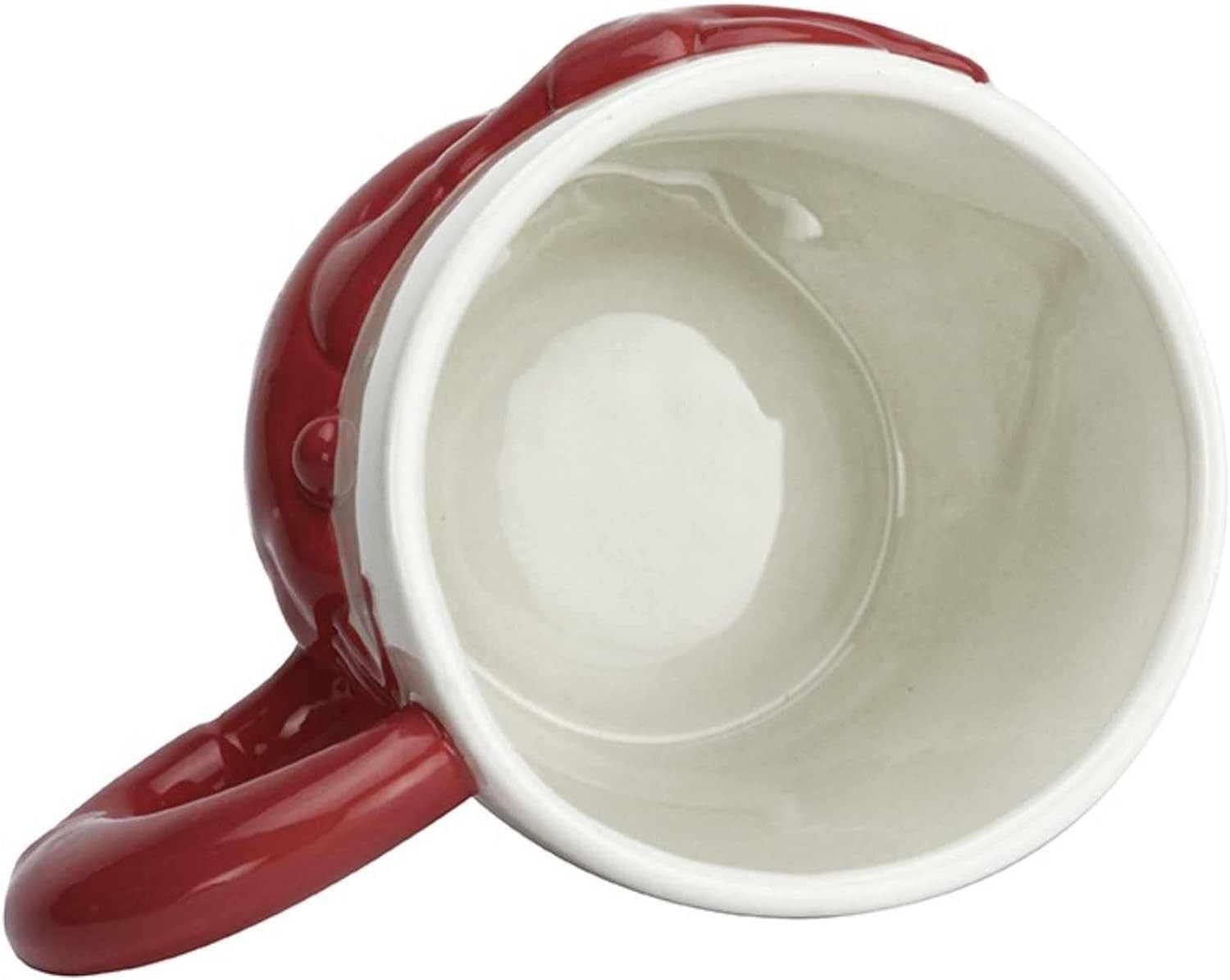 Una taza de cerámica roja con interior blanco, fotografiada desde arriba.