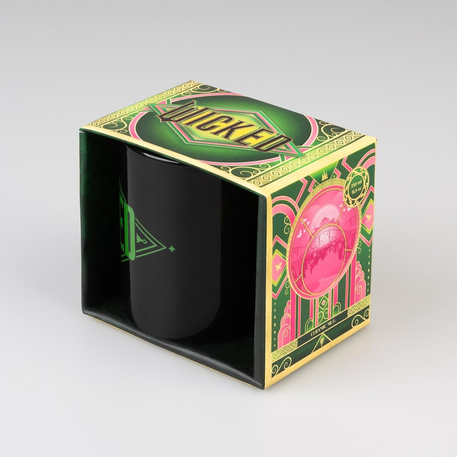 Una taza de cerámica negra con un logotipo verde en una caja decorada en verde y rosa.