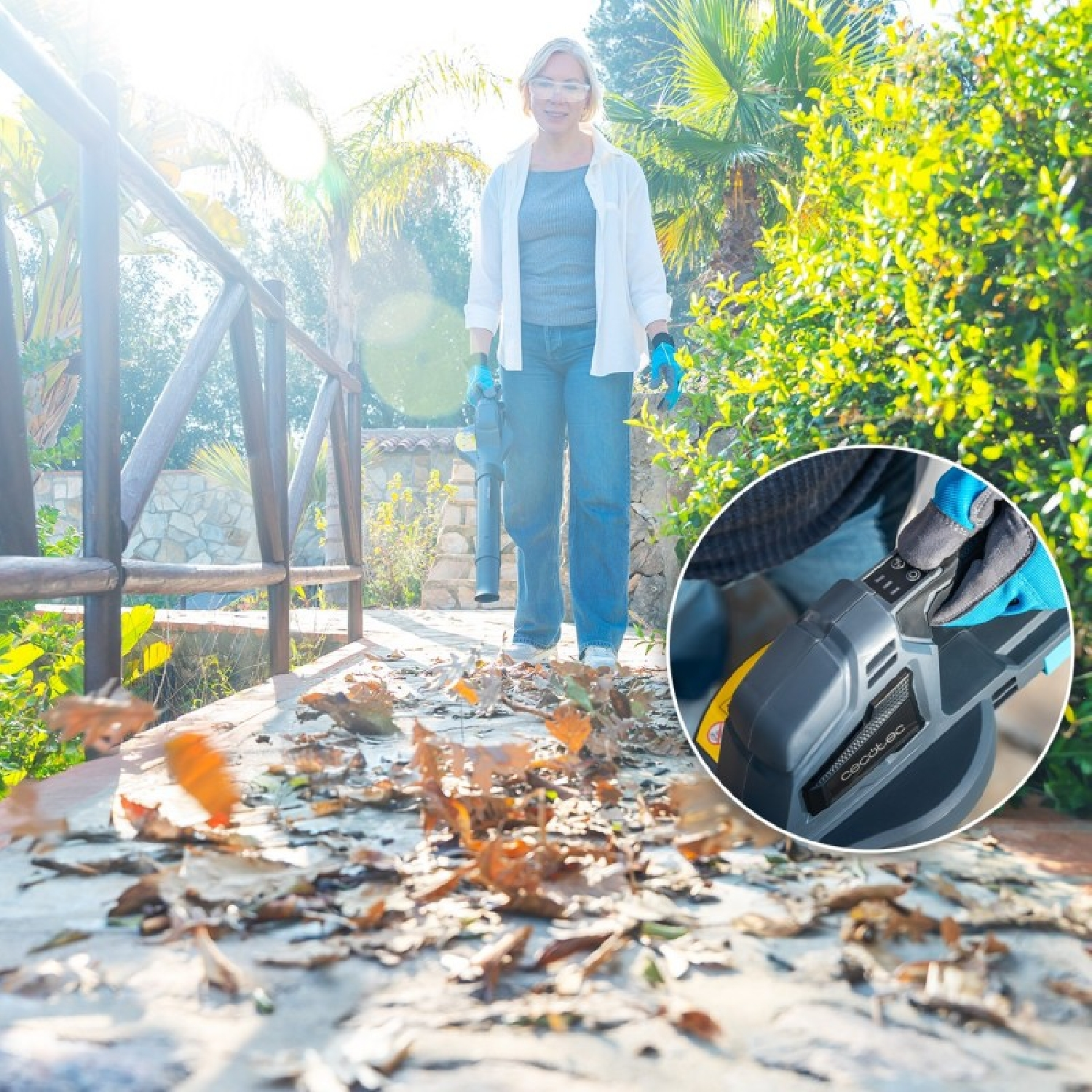 Una mujer usa un soplafuelles en un camino, con un detalle del botón de encendido.